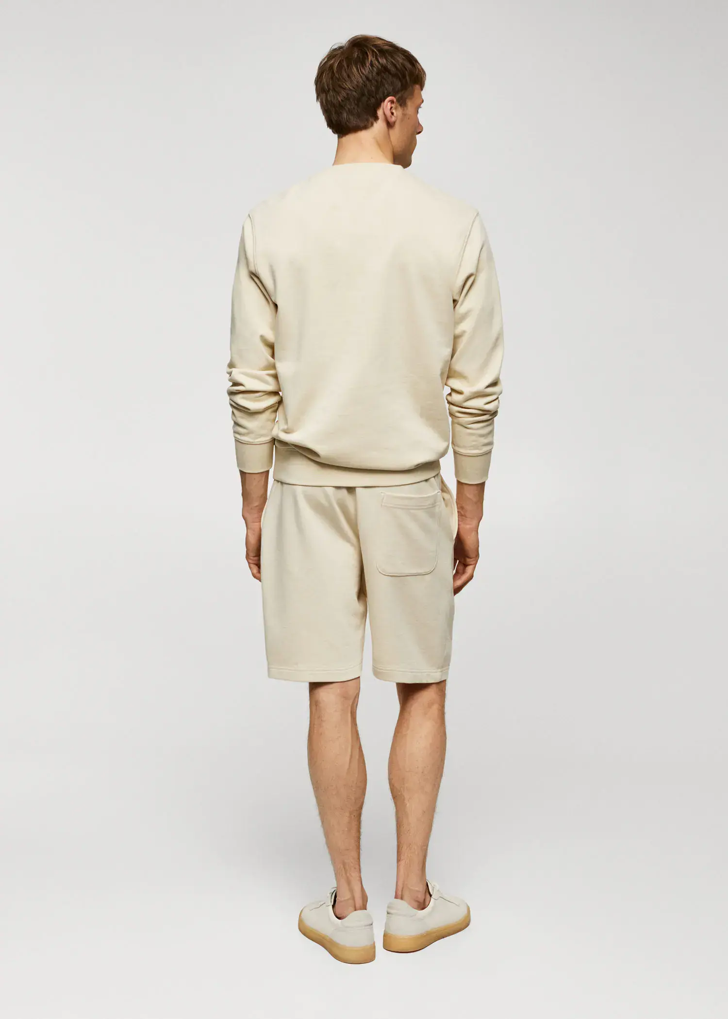 Mango 100% cotton basic sweatshirt . a man in a beige outfit stands in front of a white wall. 