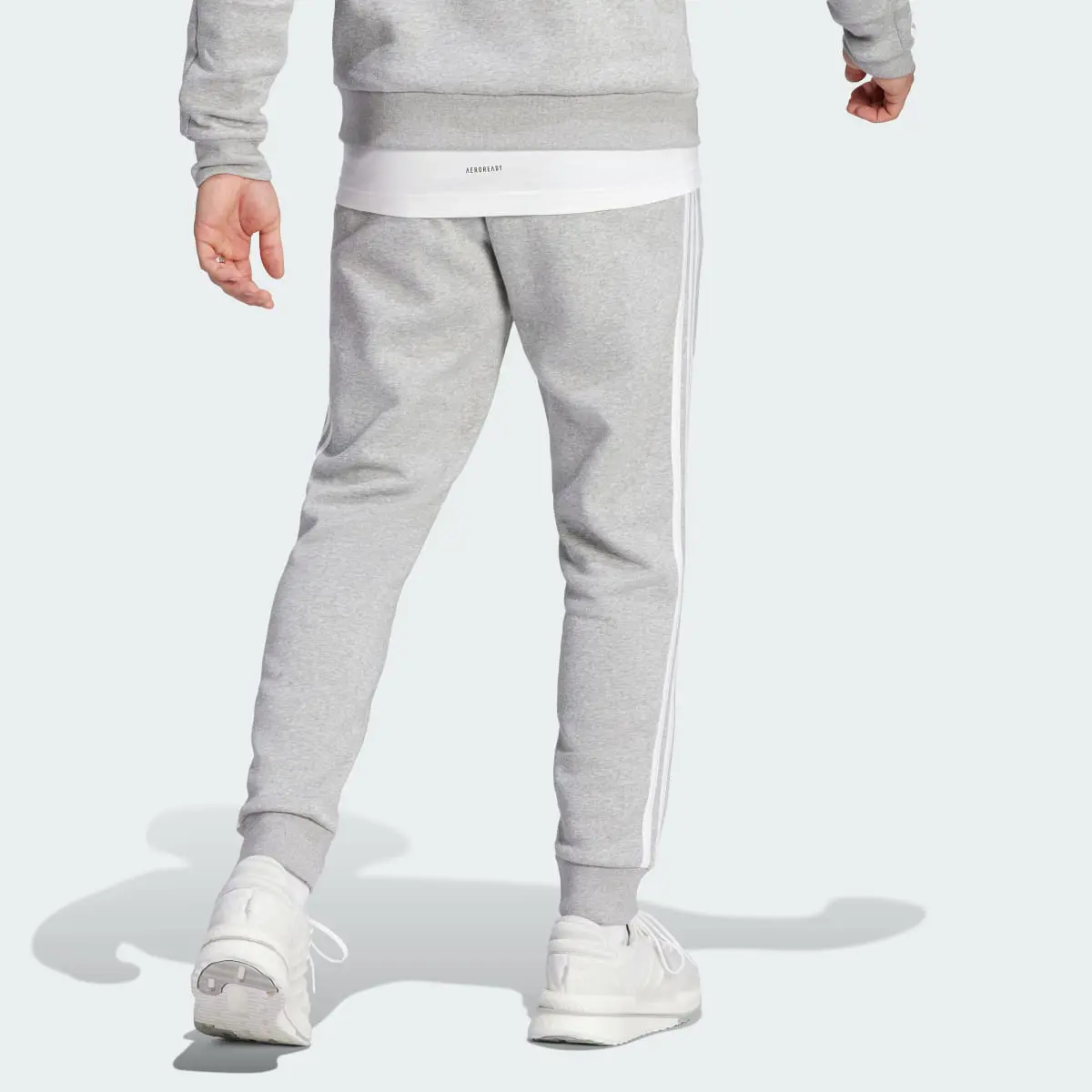 Adidas Pantaloni Essentials Fleece 3-Stripes Tapered Cuff. 2