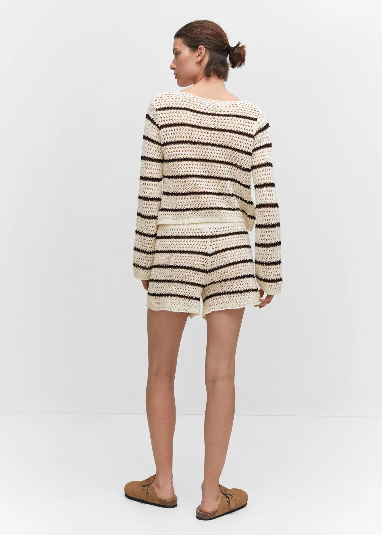 Mango Openwork knitted shorts. a woman wearing a striped sweater and shorts. 