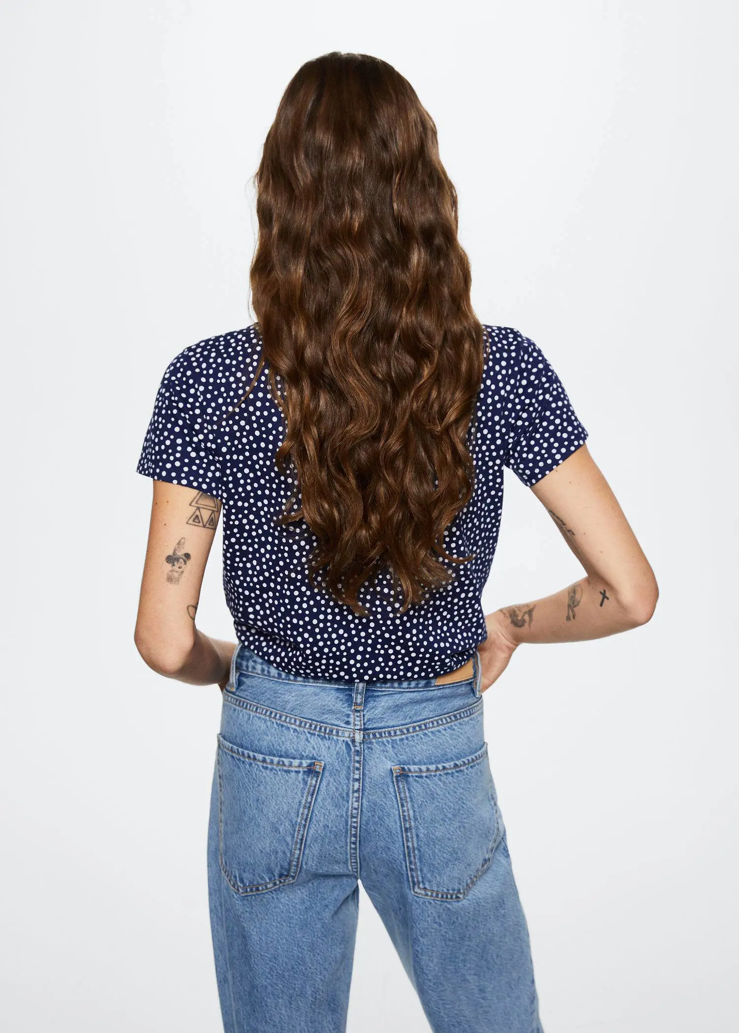 Mango Printed cotton-blend T-shirt. a woman with long brown curly hair wearing a polka dot shirt. 