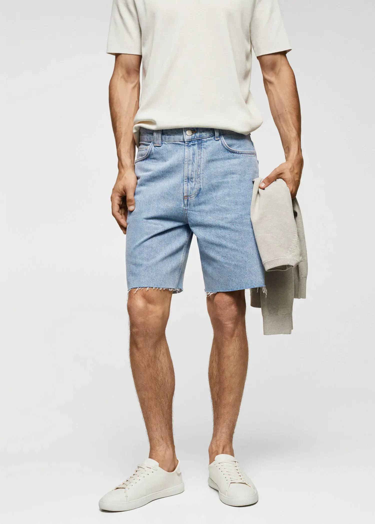 Mango Regular-fit denim bermuda shorts. a man wearing a pair of light blue denim shorts. 