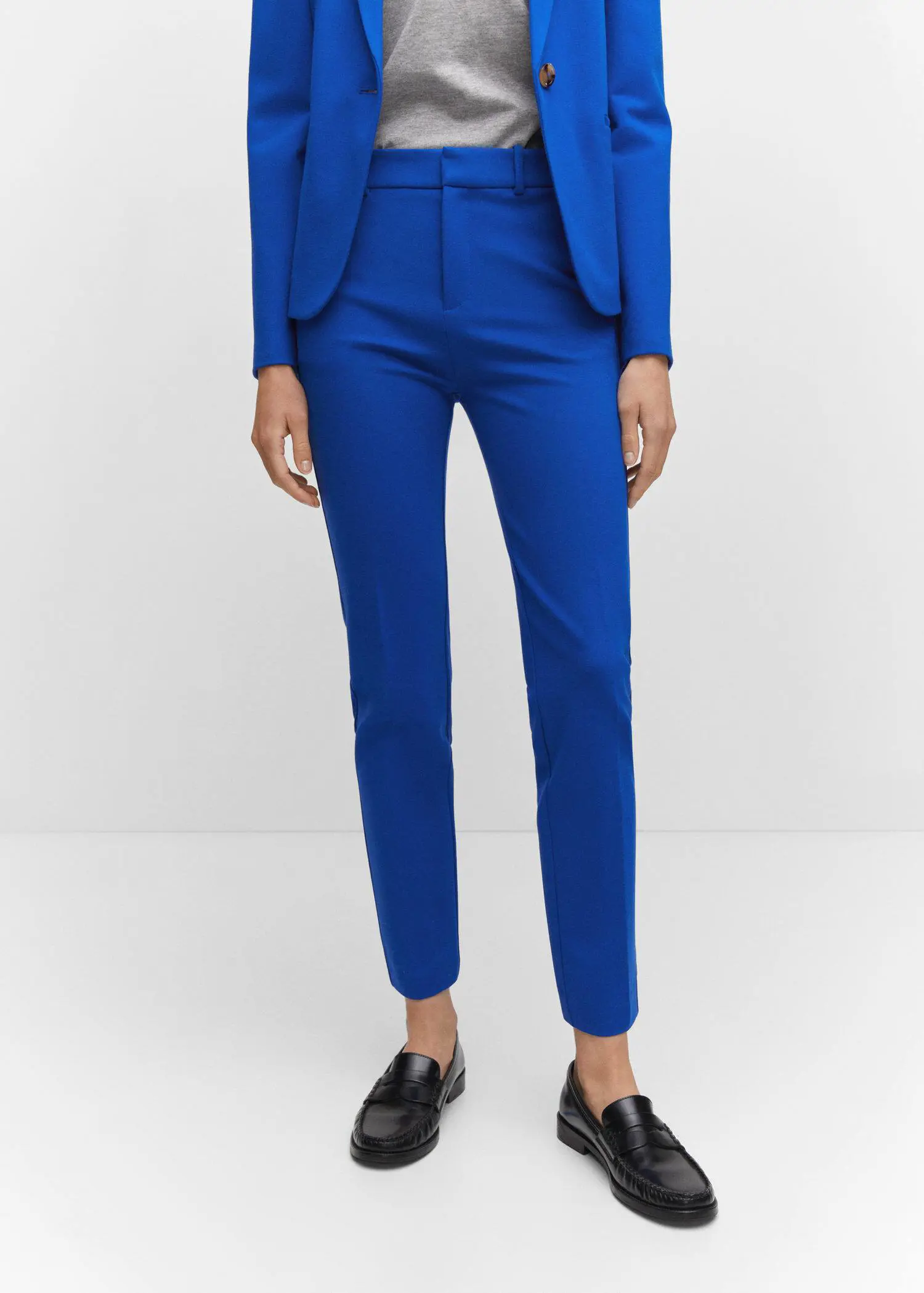 Mango Rome-knit straight pants. a woman wearing a blue suit and black shoes. 