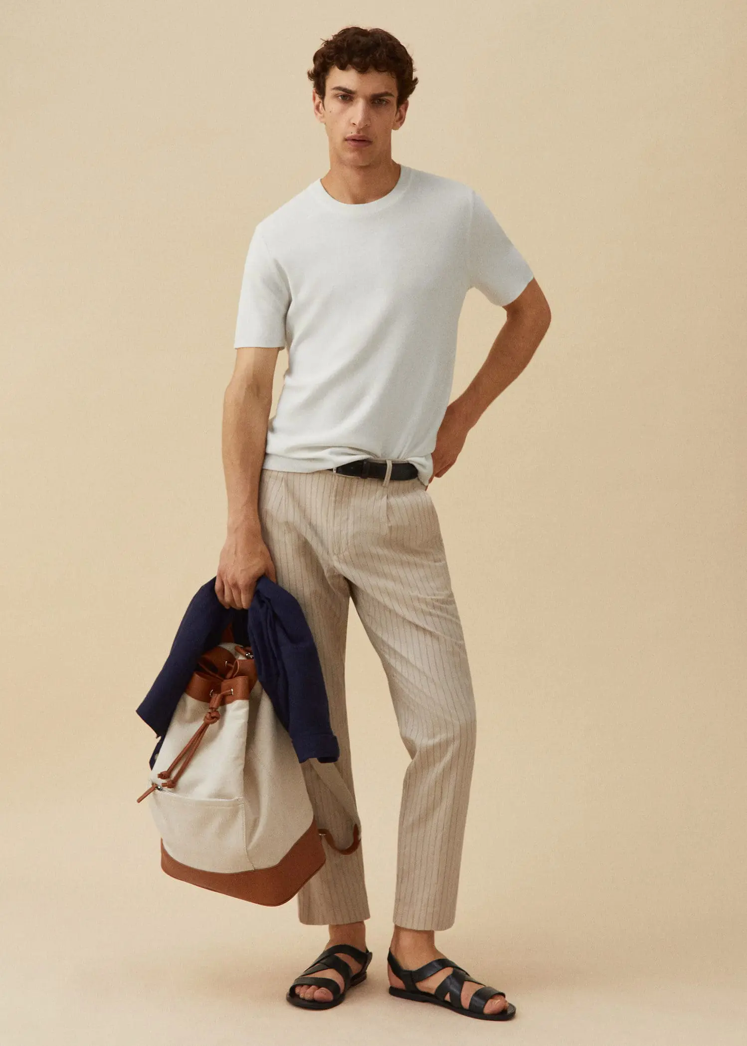 Mango Cotton-linen seersucker pants. a man in a white t-shirt is holding a bag. 