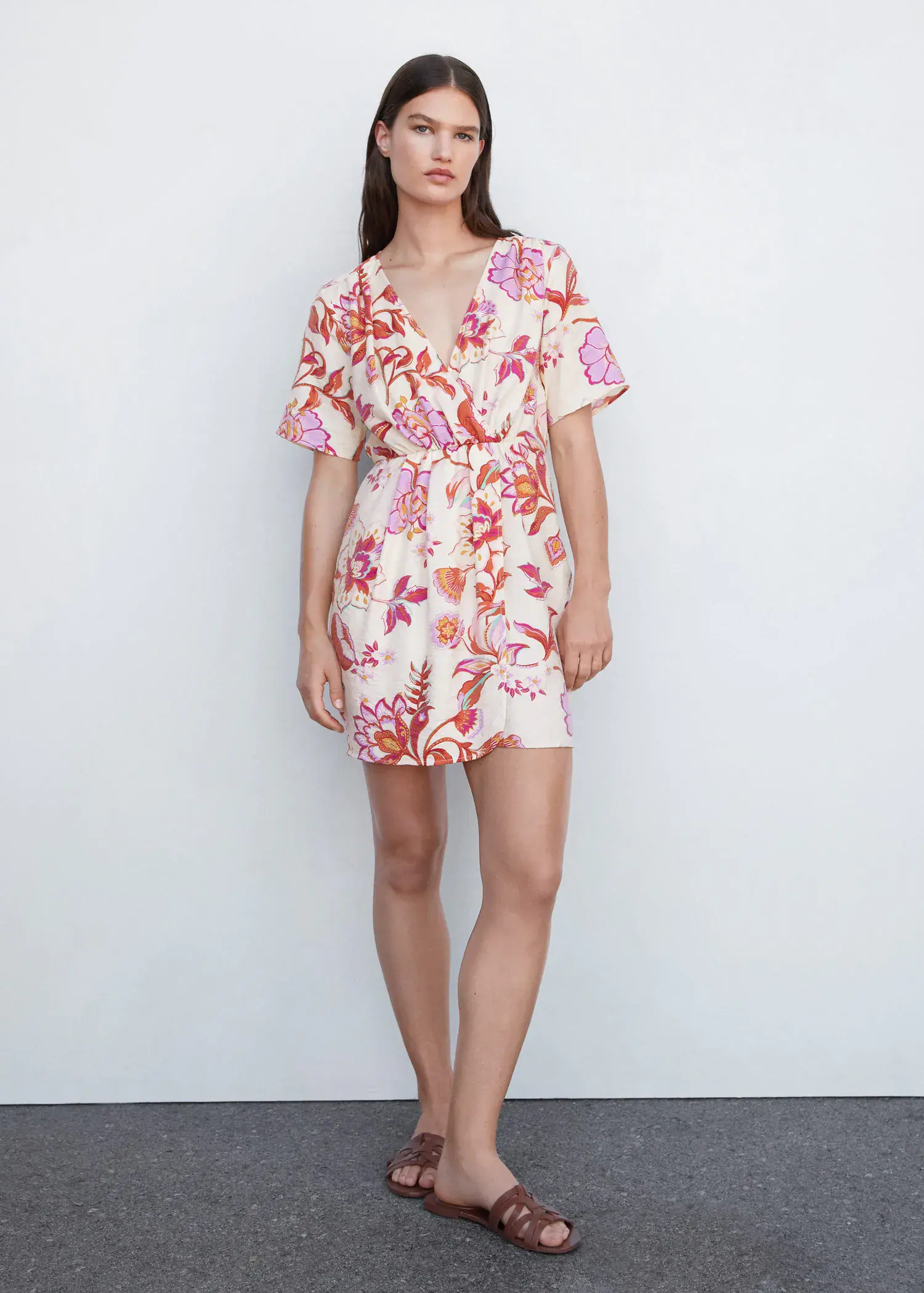 Mango Short printed wrap dress. a woman standing in front of a white wall. 