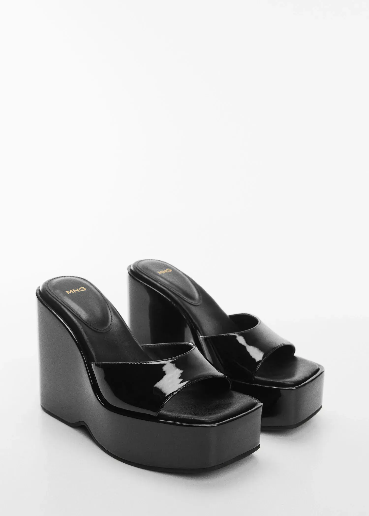 Mango Patent leather-effect platform sandals. a pair of black wedges on a white surface. 