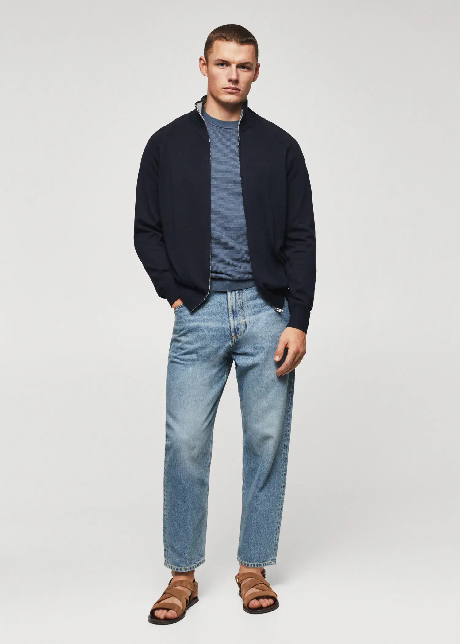 Mango Zipped cotton cardigan. a man in a black jacket and blue jeans. 