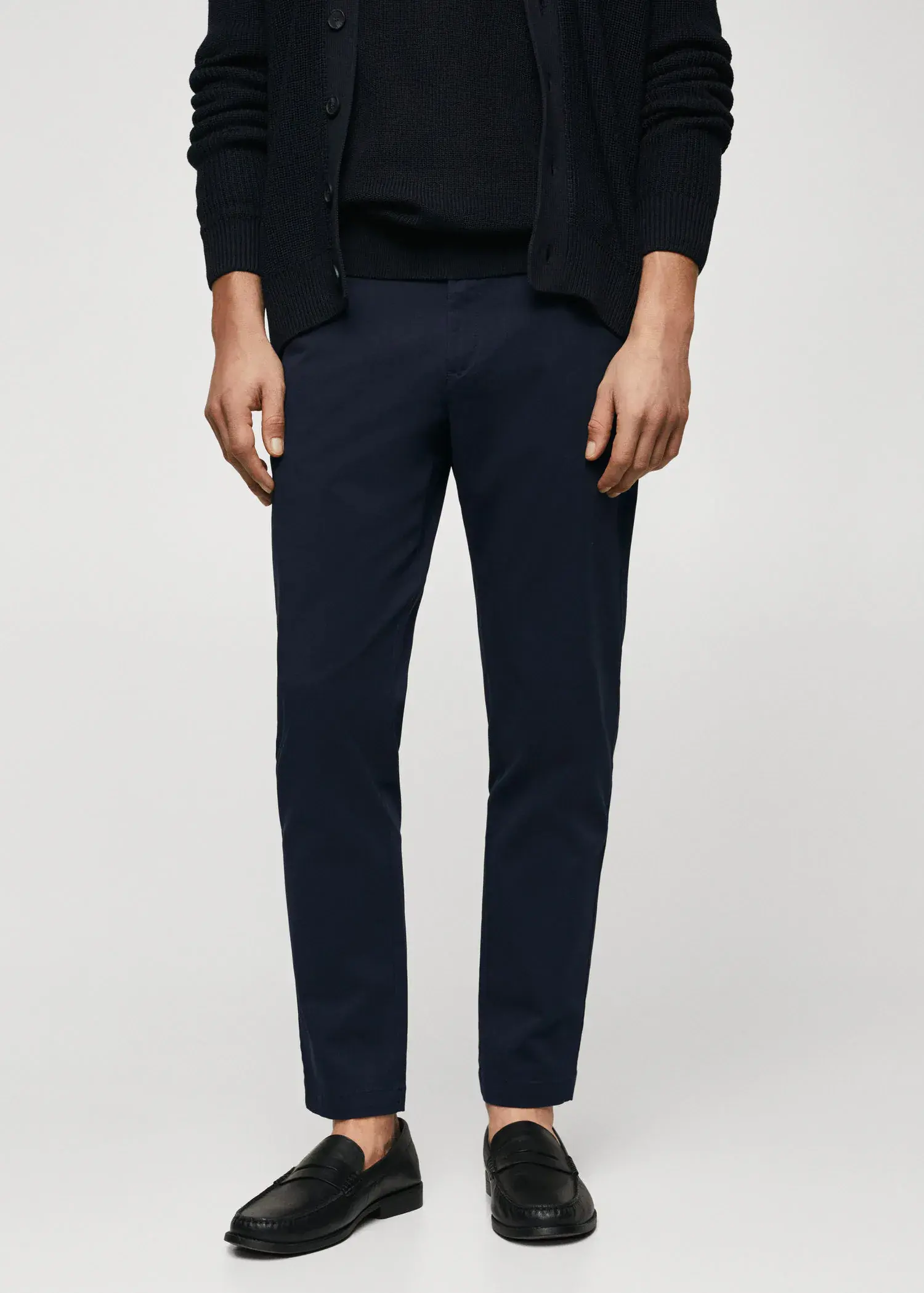 Mango Cotton tapered crop pants. a person wearing a black shirt and black pants. 