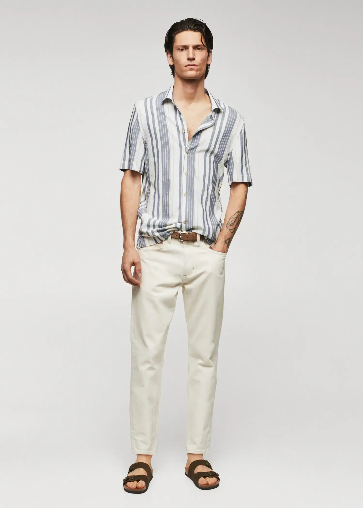 Mango Striped slim-fit shirt. a man in a striped shirt and white pants. 