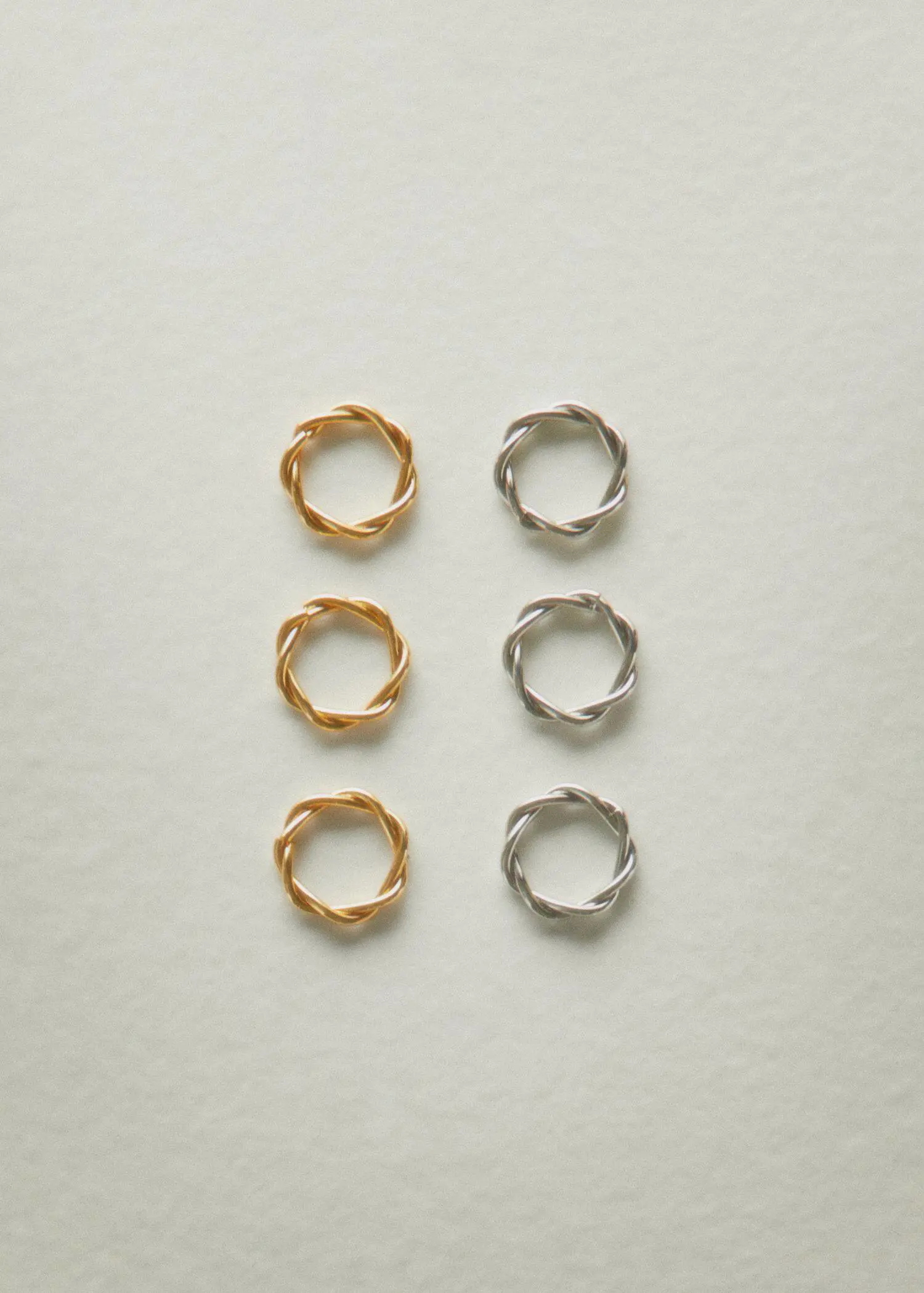 Mango Criss-cross 2 ring set. a set of six rings that are gold and silver. 