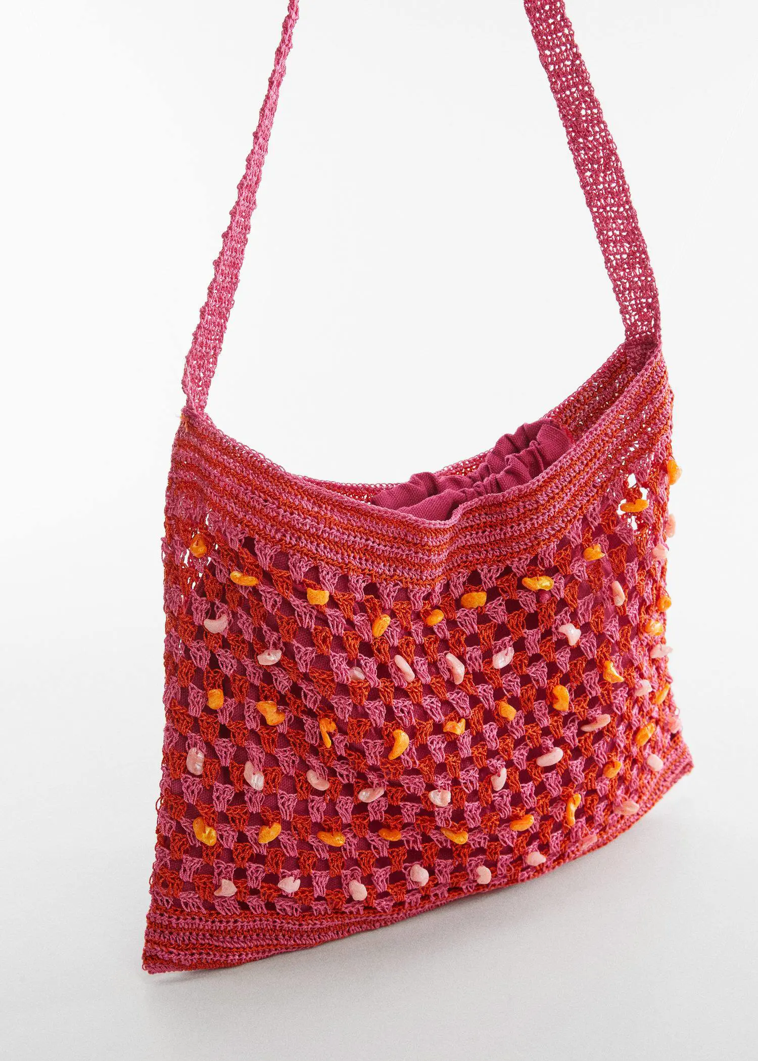 Mango Crochet bag with shell detail. a crocheted bag is shown on top of a table. 