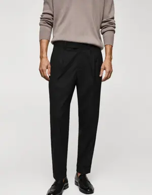 Pleated trousers under cuff