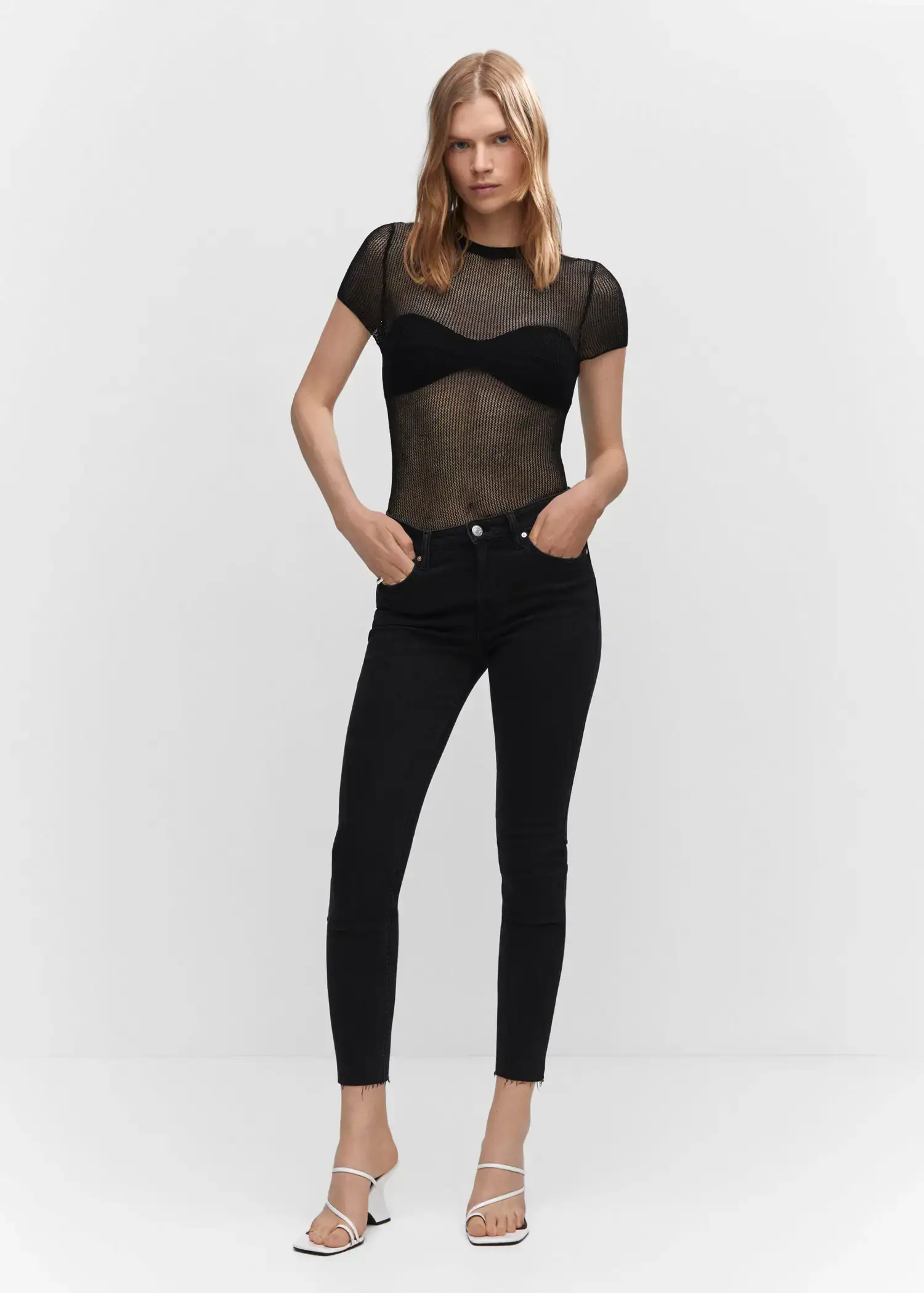 Mango Skinny cropped jeans. a woman in black pants and a black top. 