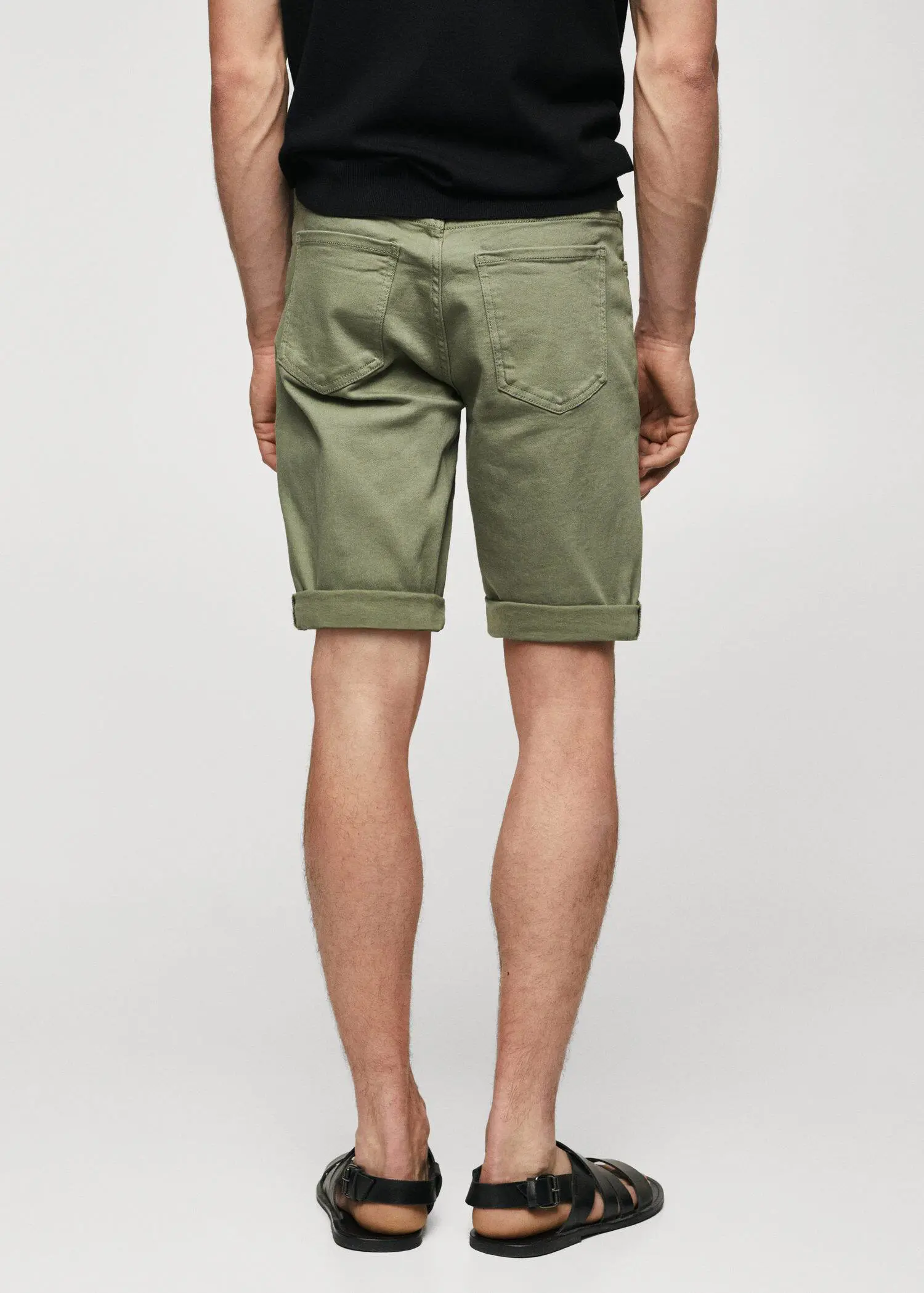 Mango Slim-fit denim bermuda shorts. a man wearing a pair of green shorts. 