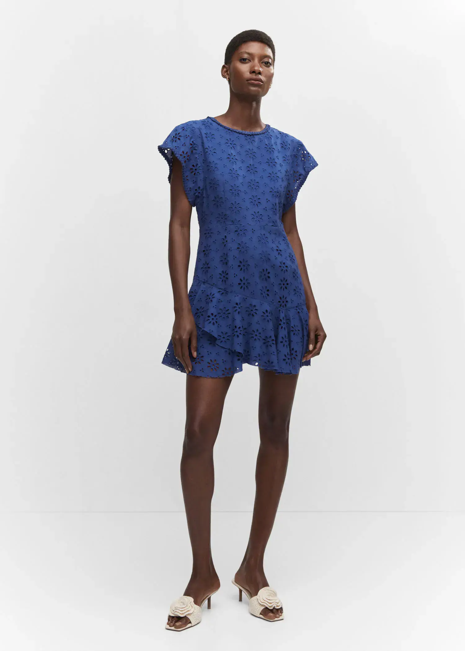 Mango Embroidered openwork dress. a woman in a blue dress standing in front of a white wall. 