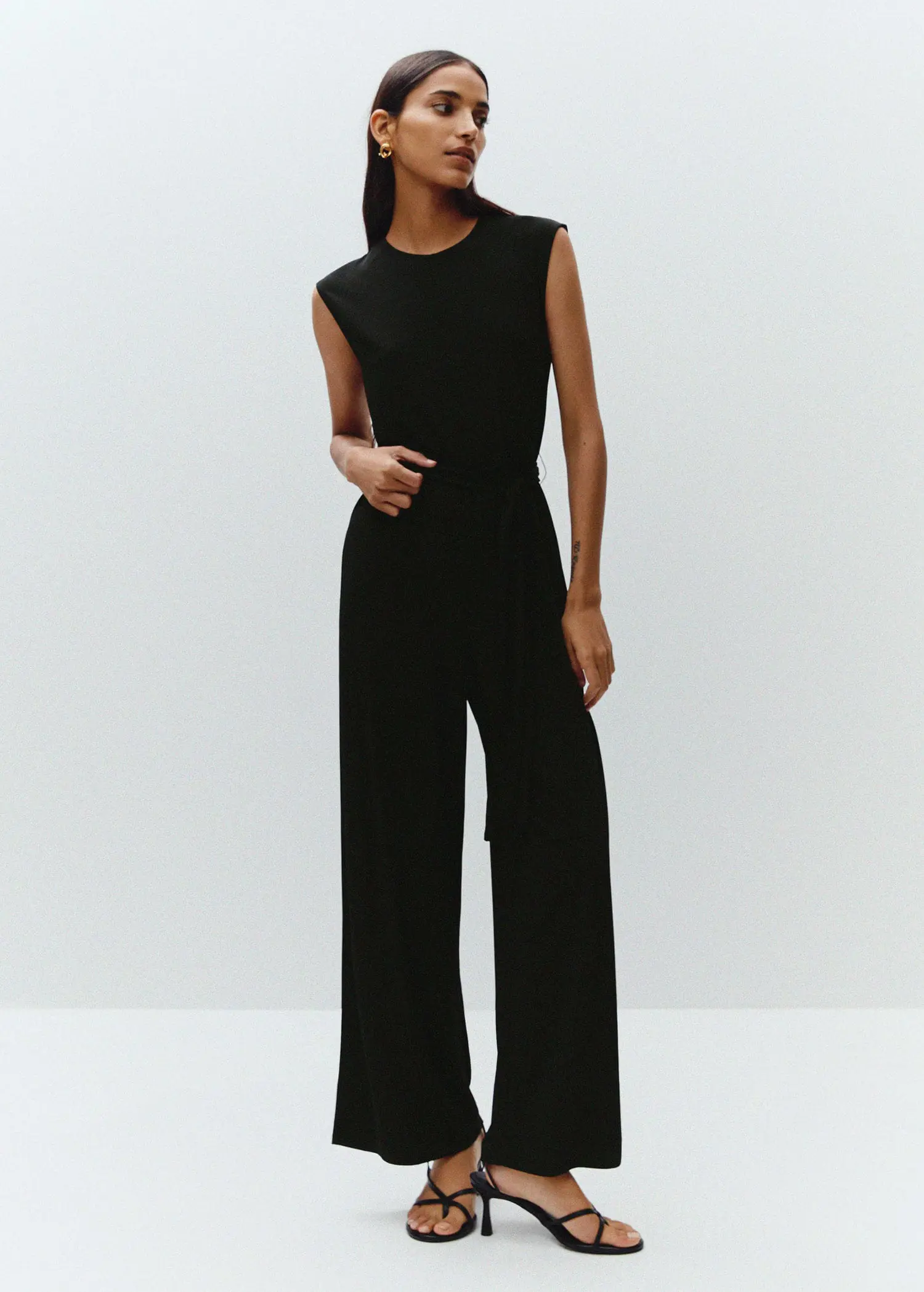 Mango Bow long jumpsuit. a woman in a black jumpsuit posing for a picture. 