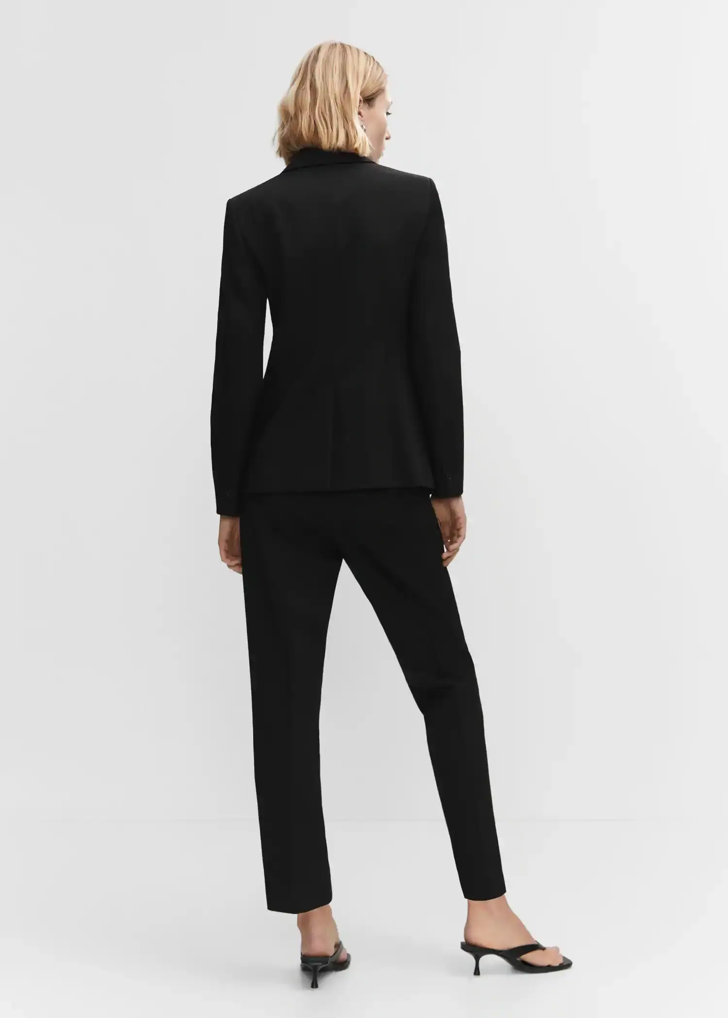 Mango Straight suit pants. a woman in a black suit is posing for a picture. 
