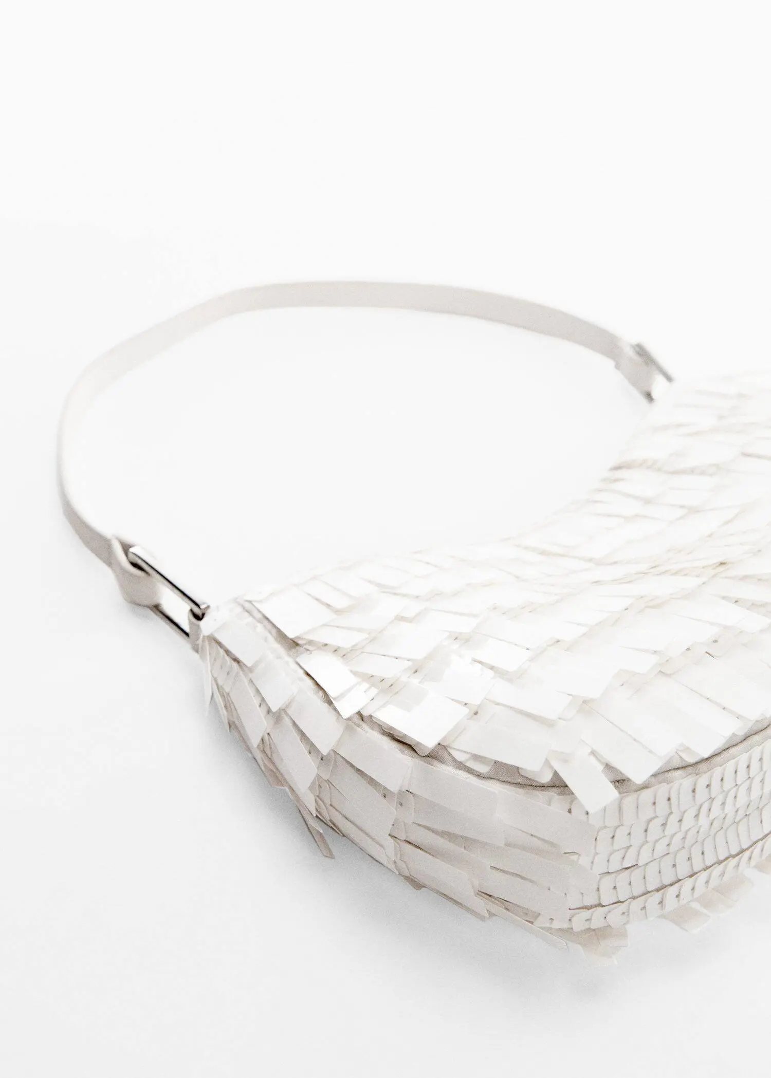 Mango Fringed shoulder bag. a close up of a white purse on a table. 