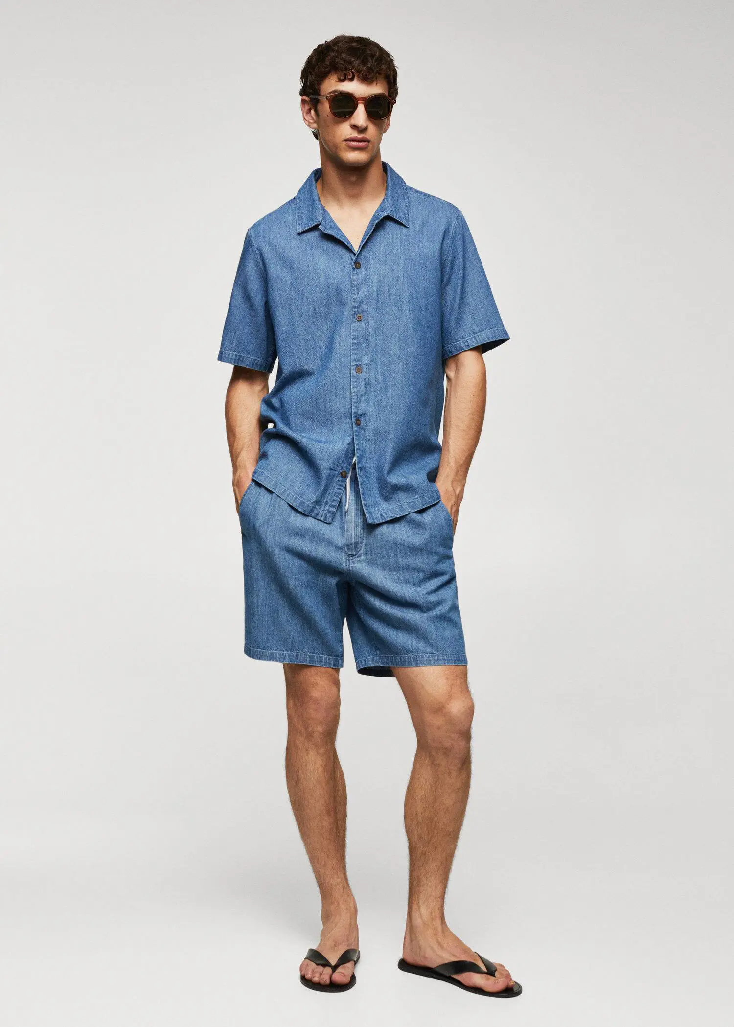 Mango Chambray Bermuda shorts. a man in a blue shirt and shorts. 