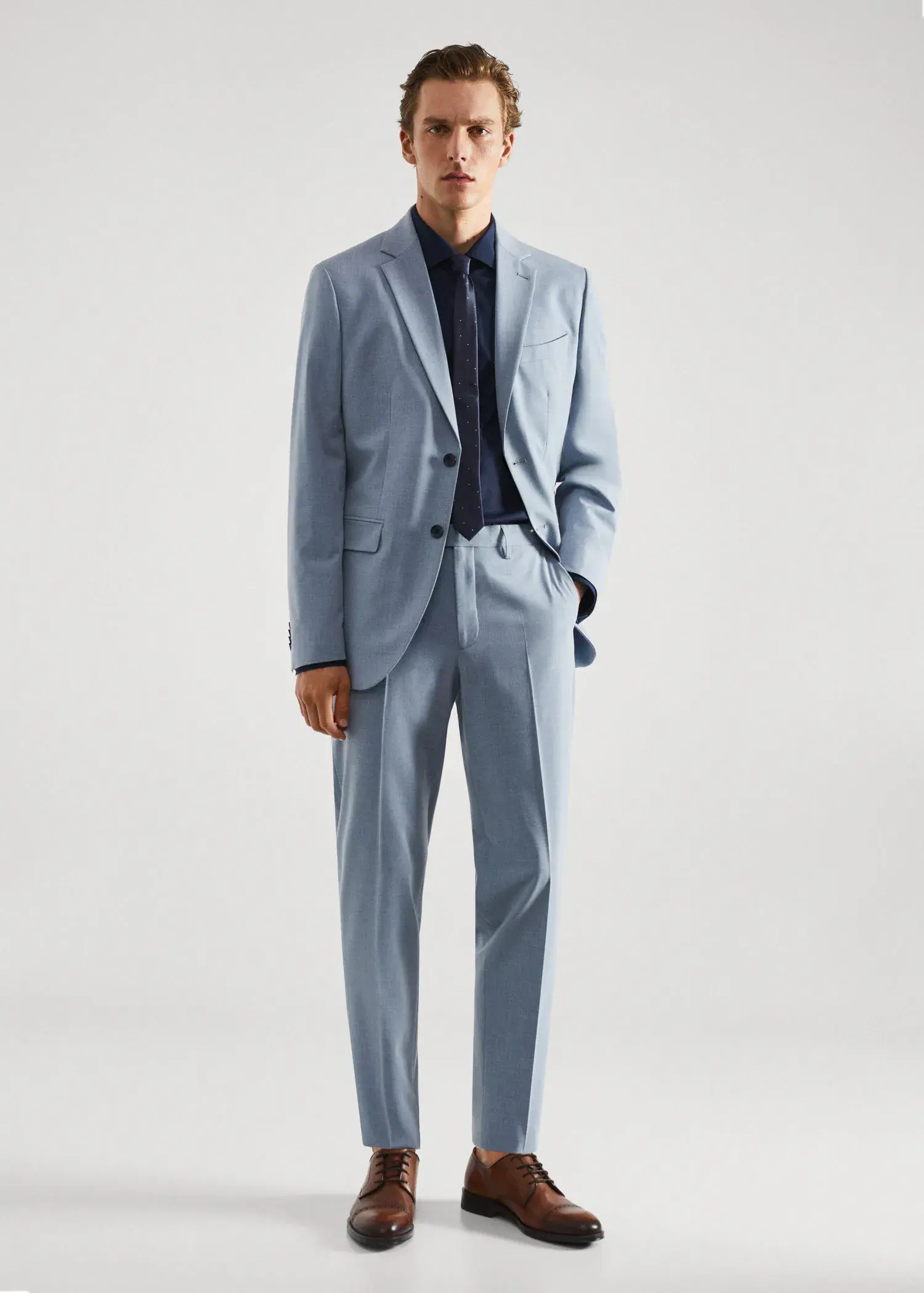Mango Slim-fit cotton poplin suit shirt. a man in a suit standing in front of a white wall. 
