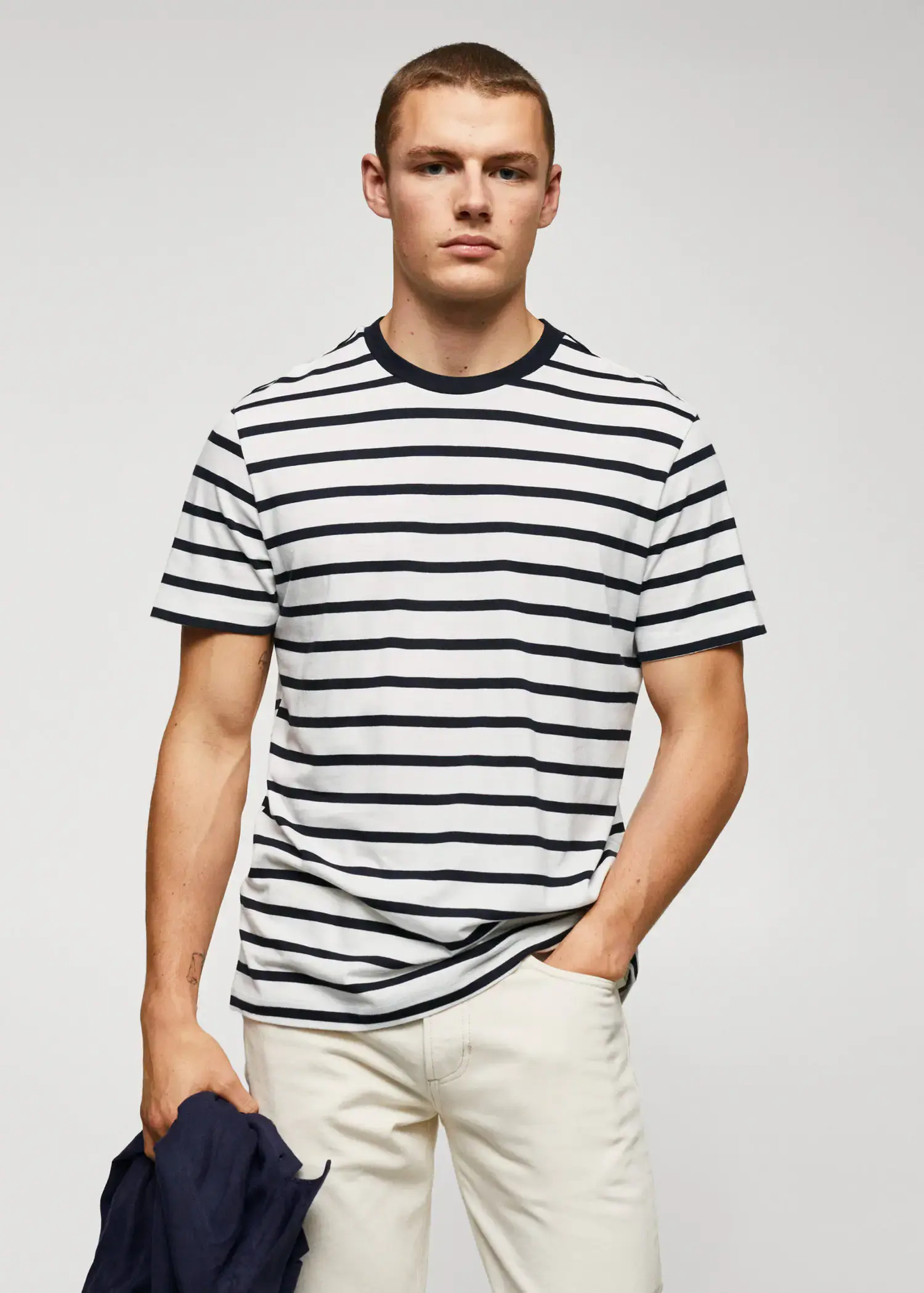 Mango Cotton-modal striped t-shirt. a young man wearing a striped t-shirt. 