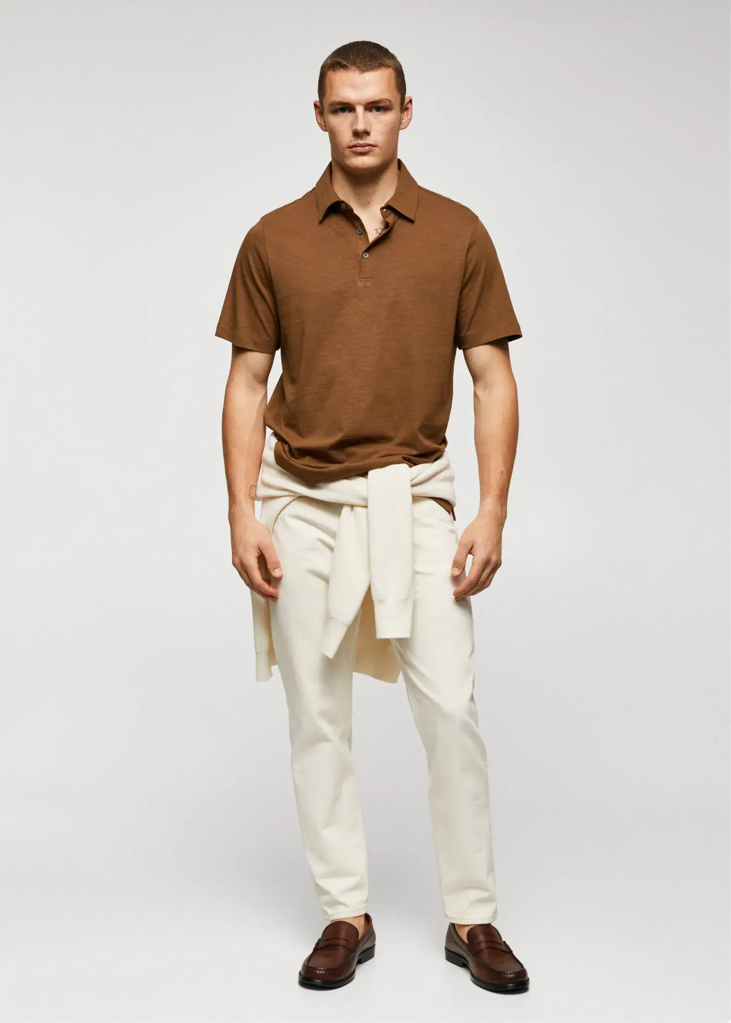 Mango 100% cotton basic polo shirt . a man in a brown polo shirt and white pants. 