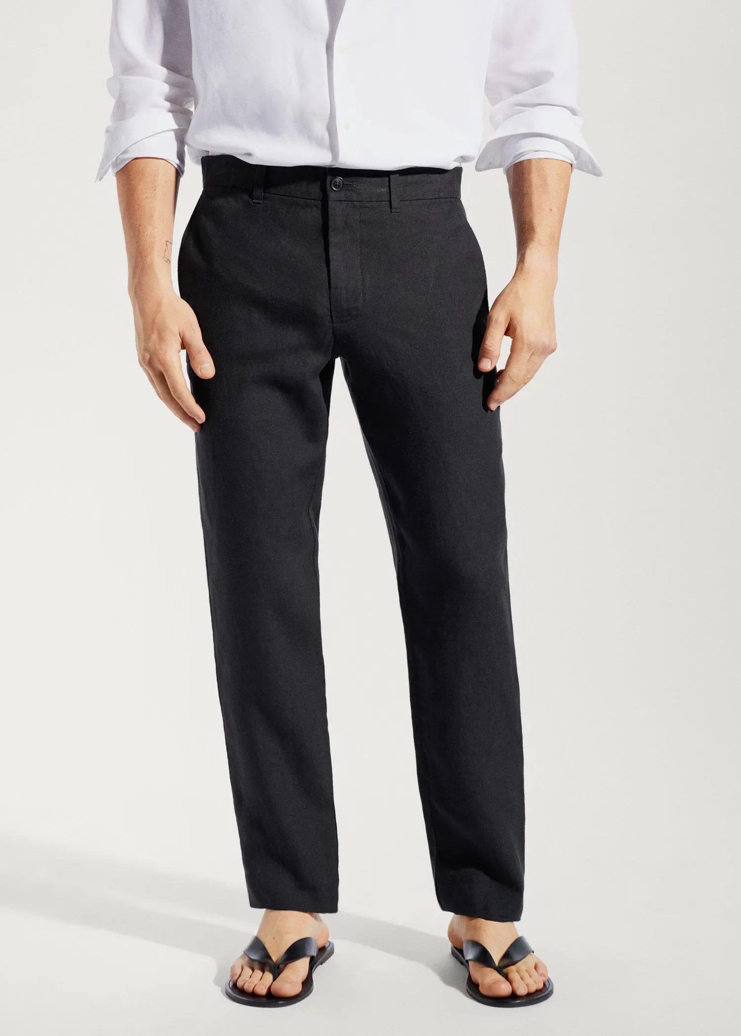 Mango Slim-fit 100% linen pants. a man wearing a white shirt and black pants. 