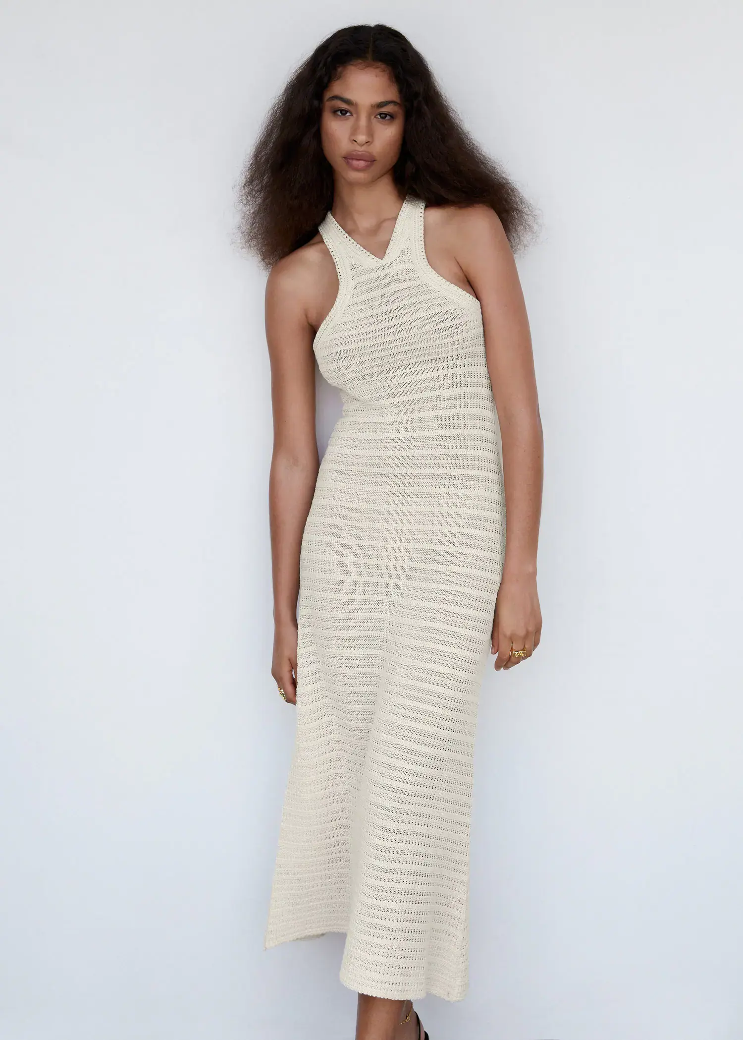 Mango Halter-neck crochet dress. a woman in a white dress standing in front of a white wall. 