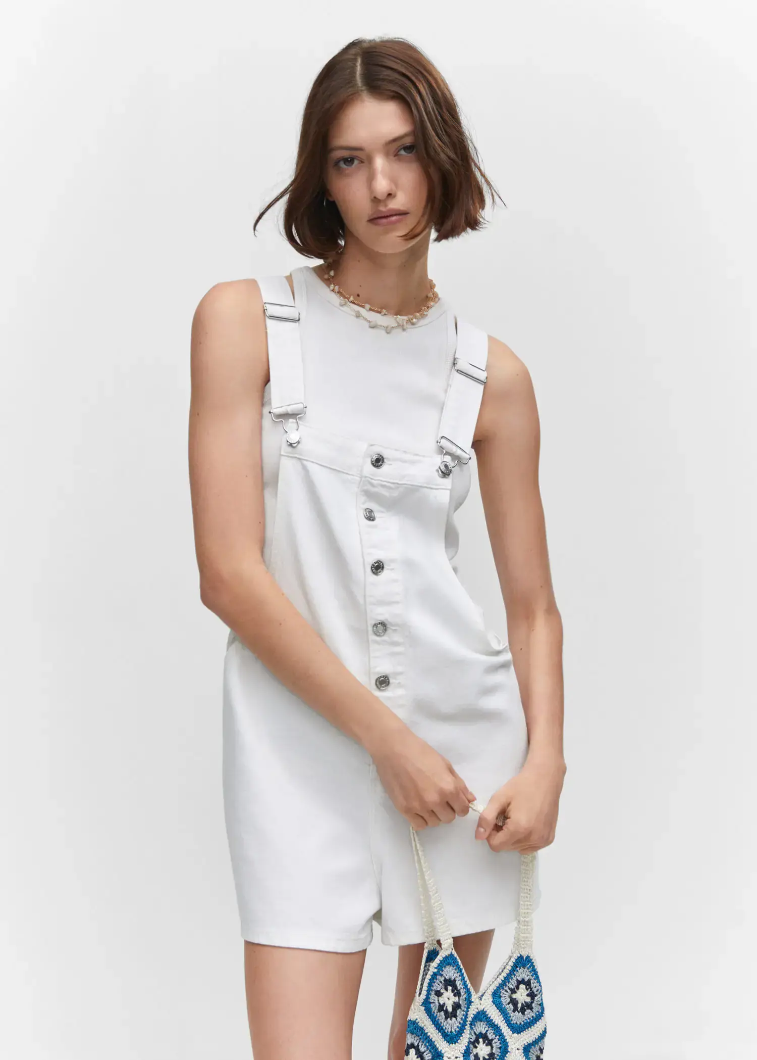 Mango Denim button-down dungarees. a woman in a white dress posing for a picture. 