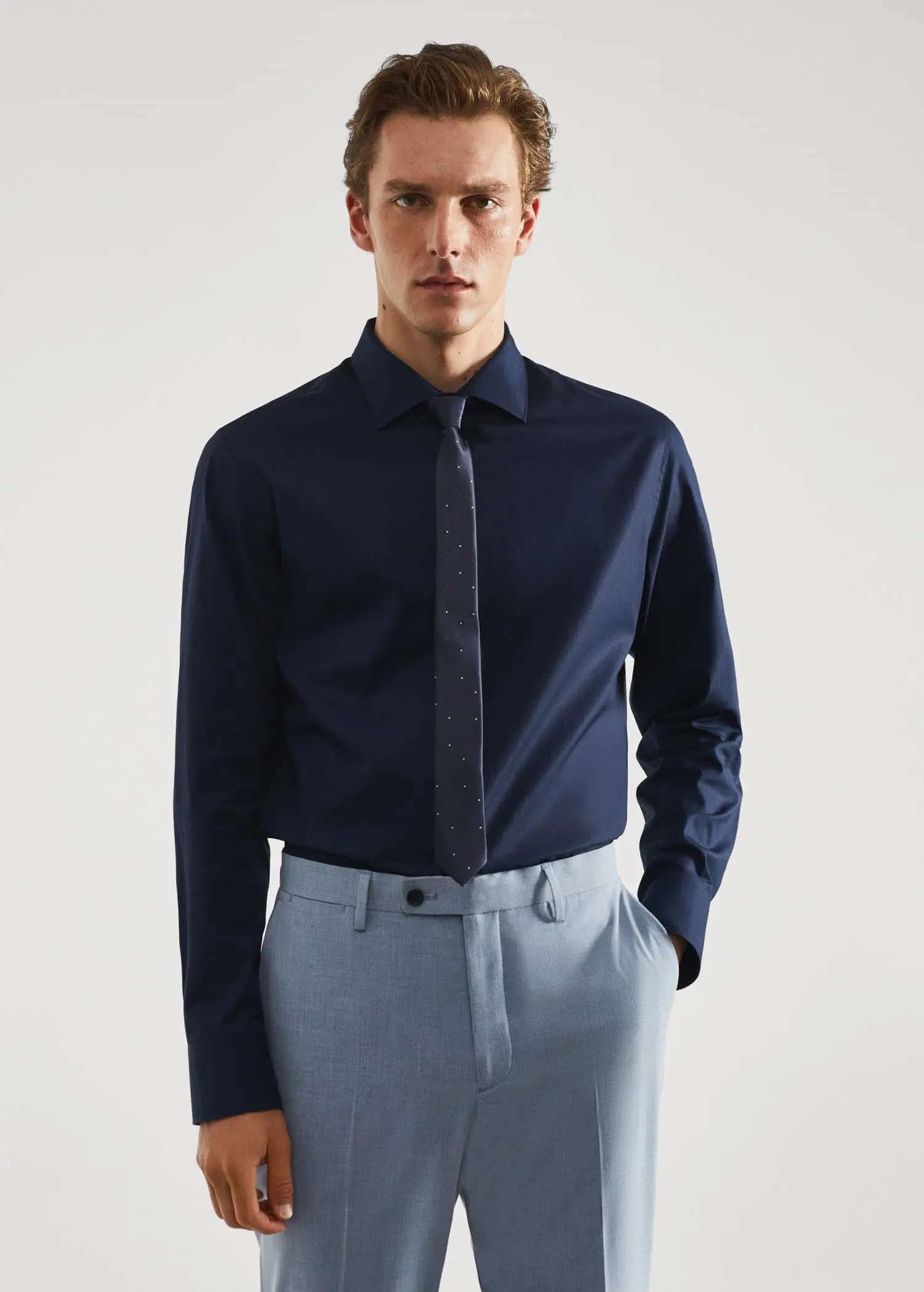 Mango Slim-fit cotton poplin suit shirt. a man in a suit and tie standing with his hands in his pockets. 
