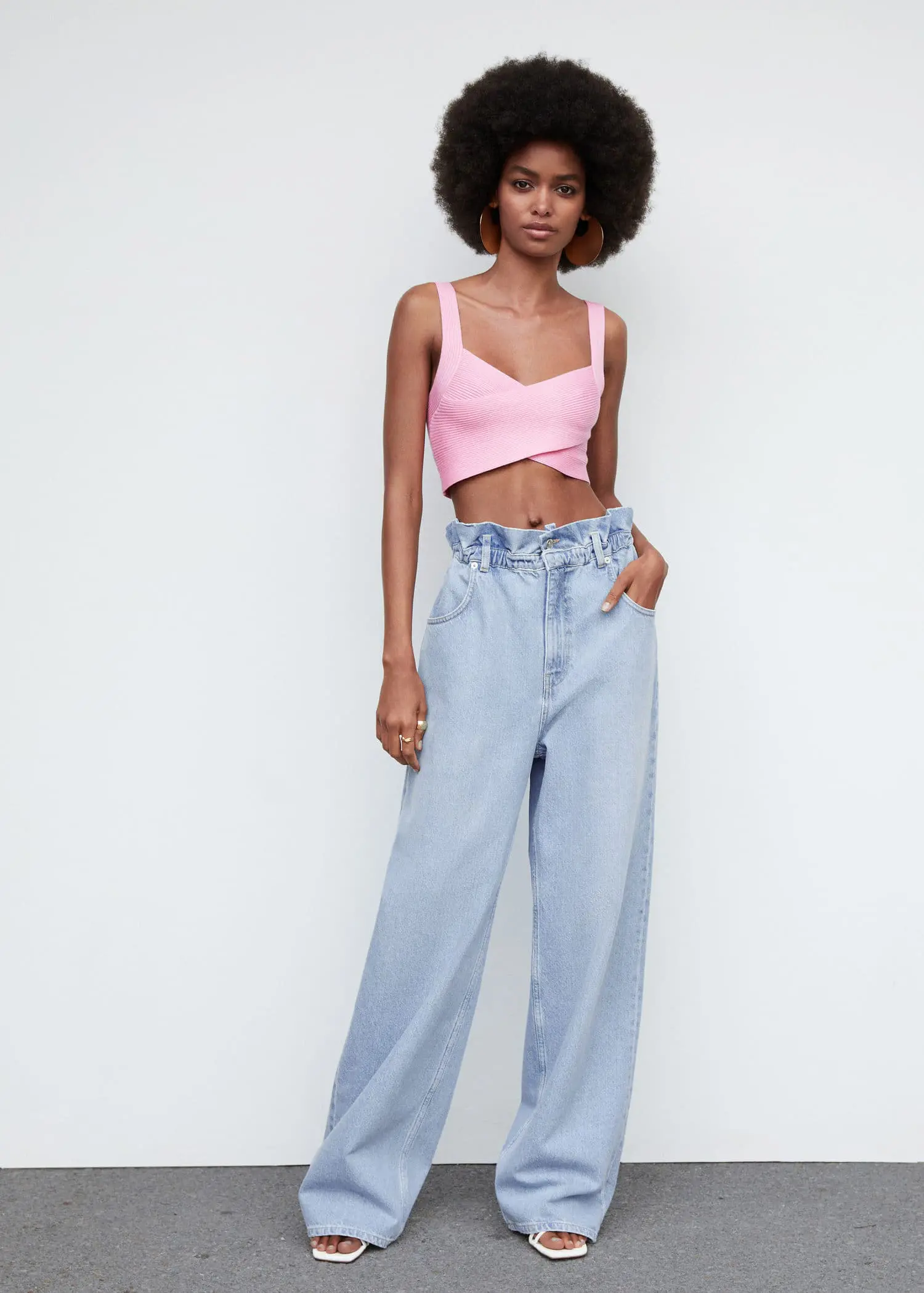 Mango Waist straight Slouchy jeans. a woman in a pink top and blue jeans. 
