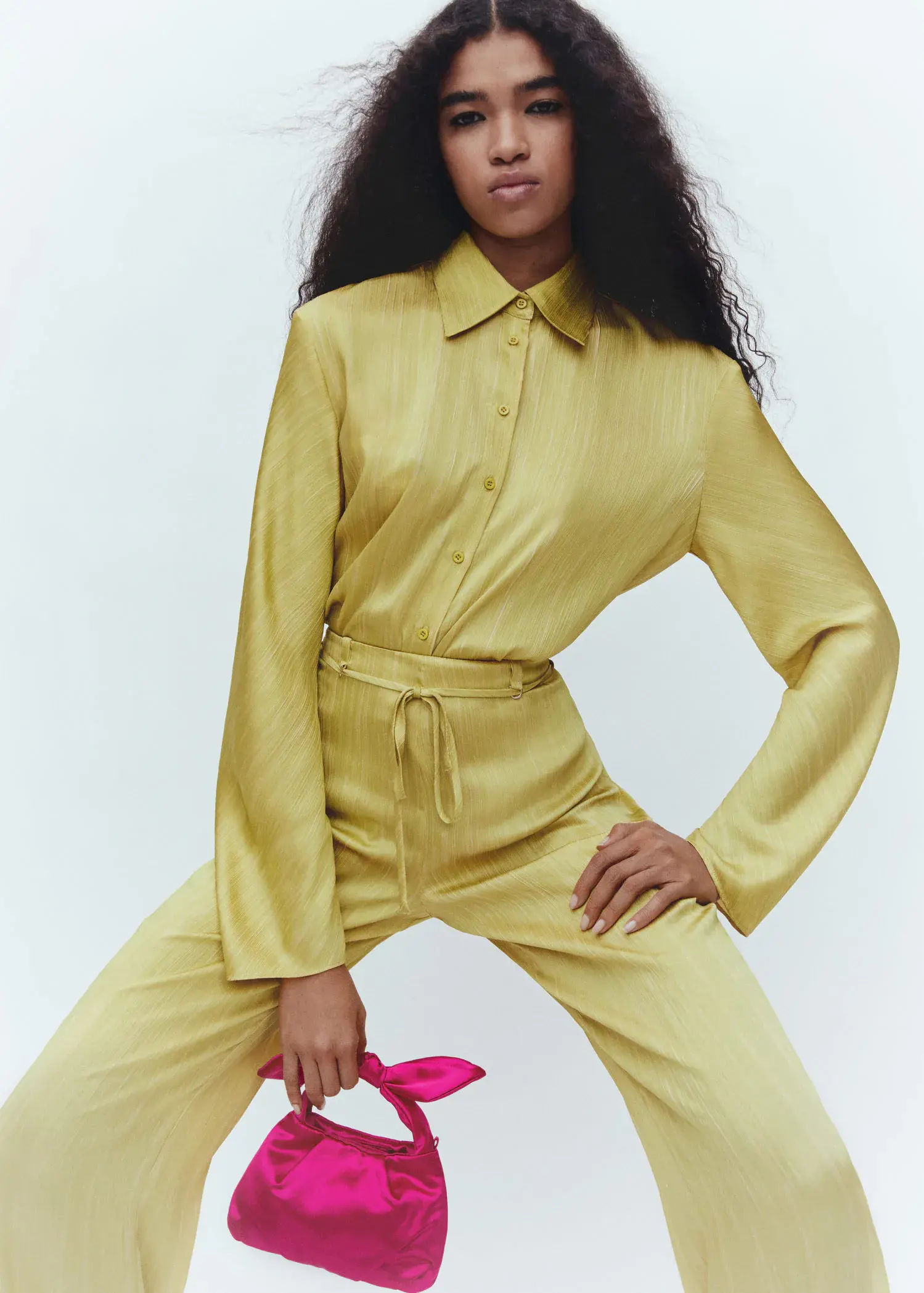 Mango Satin pleated shirt. a woman in a yellow outfit posing for a picture. 