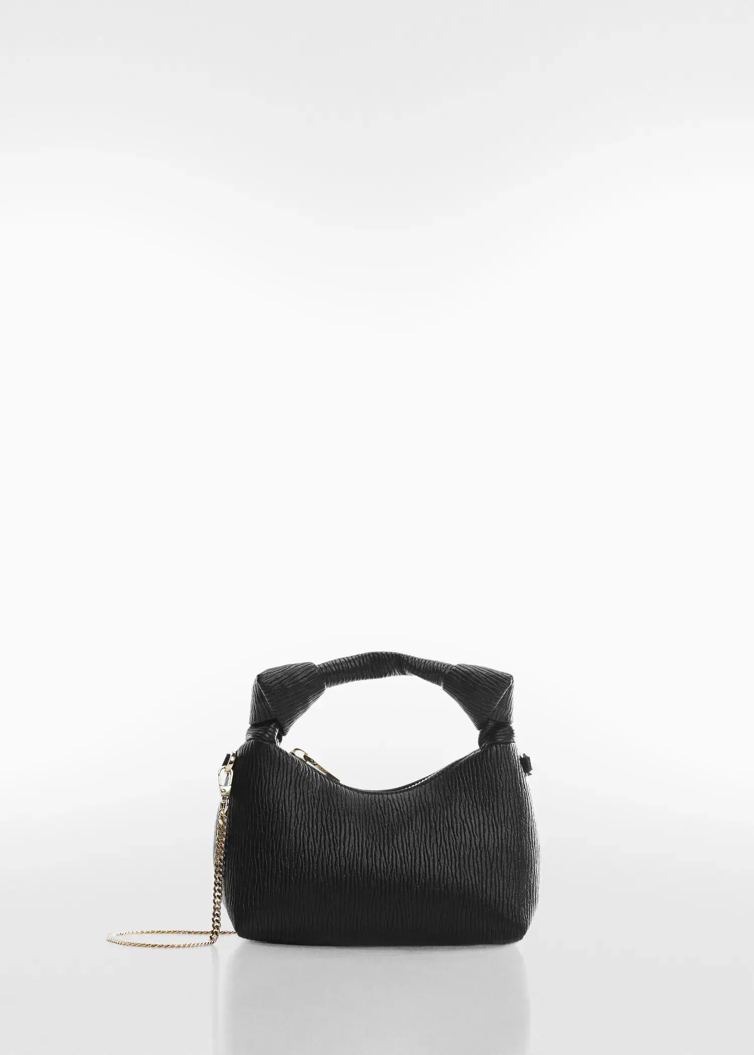 Mango Textured knot handle bag. a close up of a black bag on a white background 