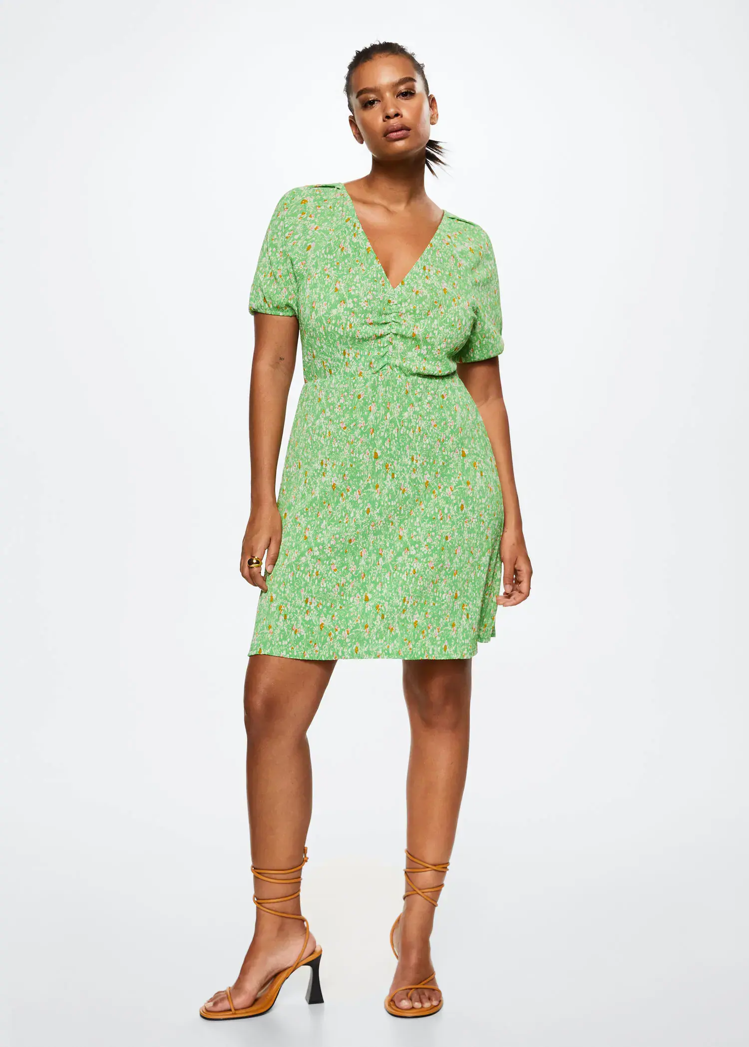 Mango Floral print dress. a woman wearing a green dress standing in a room. 