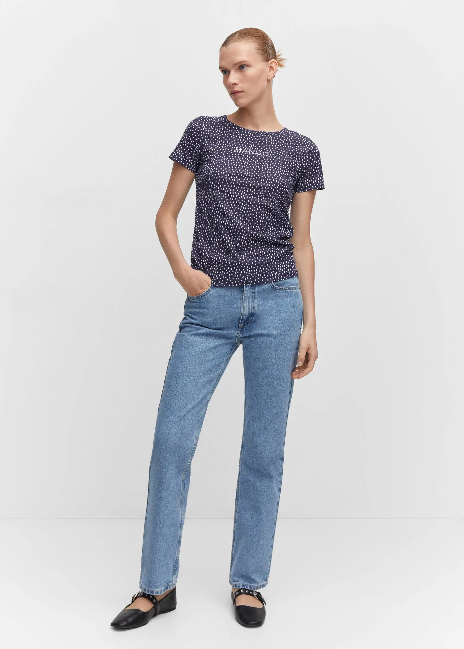 Mango Embroidered logo print t-shirt. a woman wearing a blue shirt and jeans. 