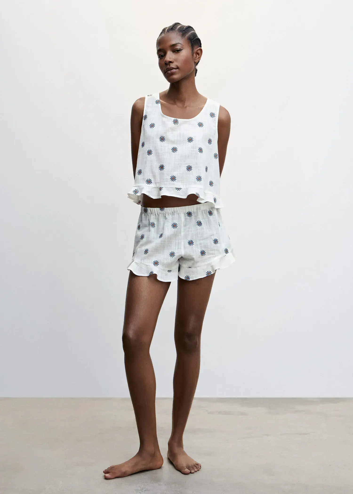 Mango Floral embroidered pajama shorts. a woman standing in a room wearing a polka dot outfit. 