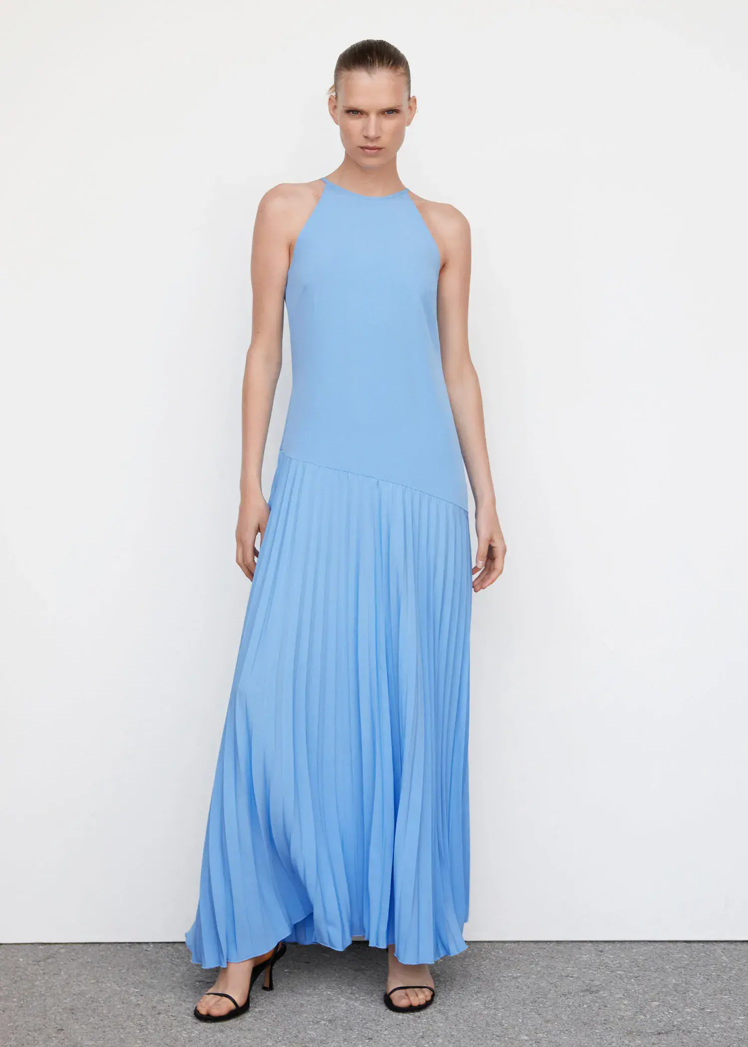 Mango Pleated panel dress. a woman wearing a blue dress standing in a room. 