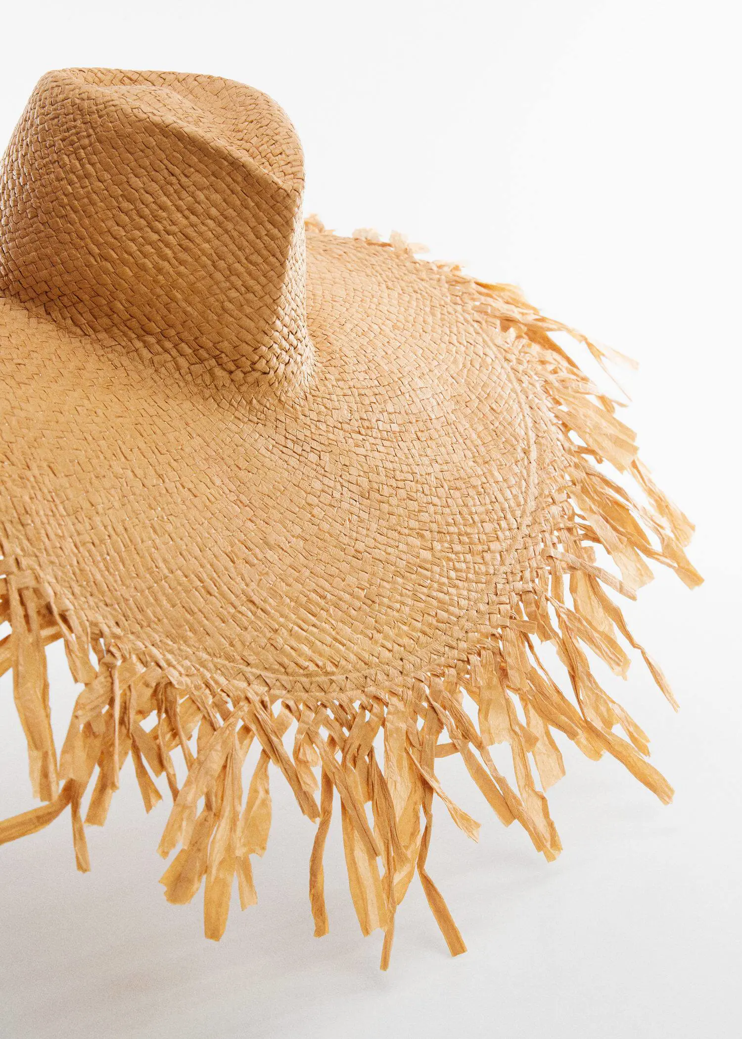 Mango Natural fibre maxi hat. a close up view of a straw hat with fringes 