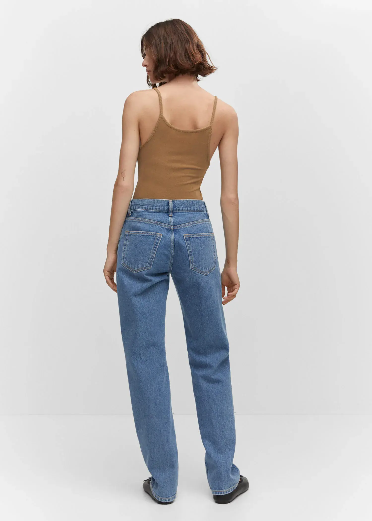 Mango Mid-rise straight jeans. a woman wearing a brown tank top and blue jeans. 
