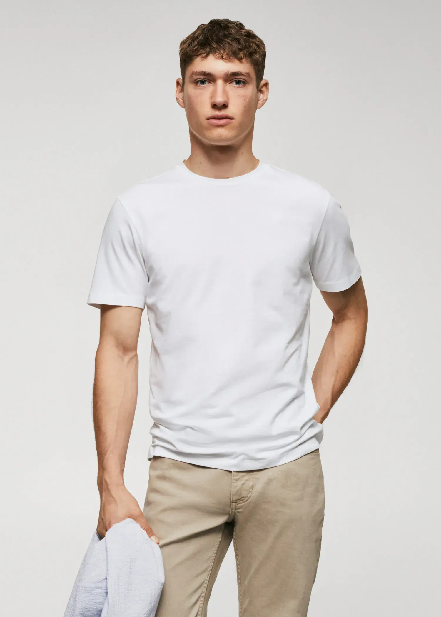 Mango Basic lightweight cotton t-shirt. a man in a white shirt is holding a tennis ball. 