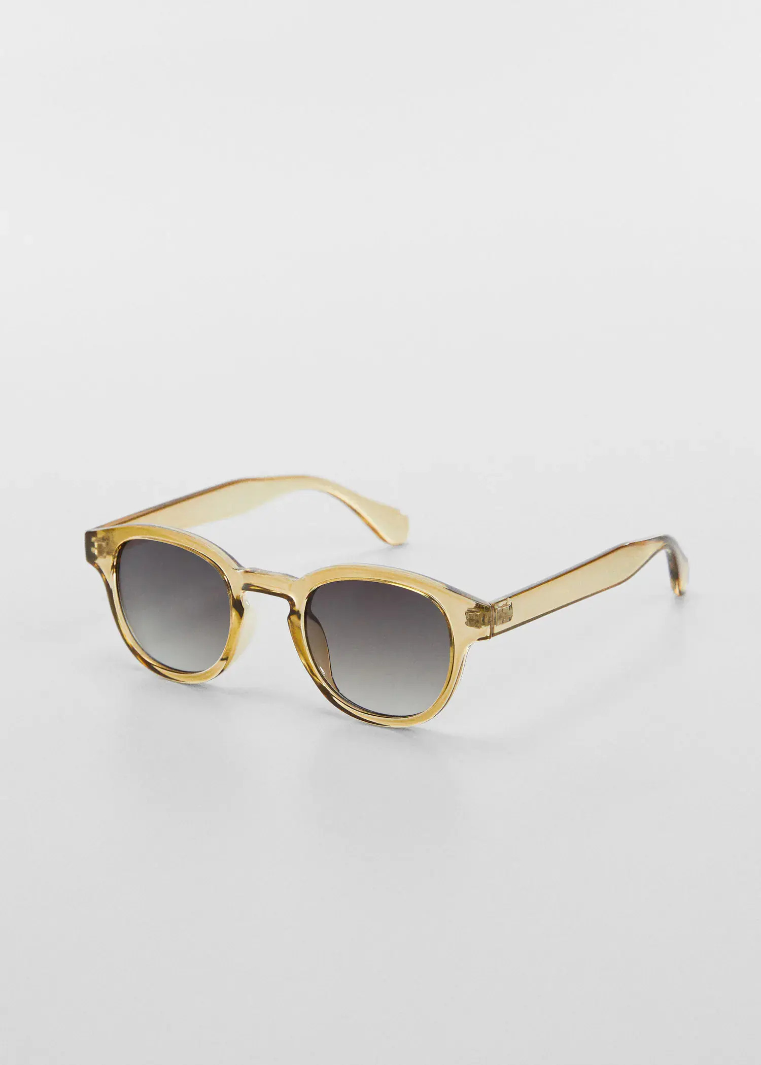 Mango Rounded sunglasses. a pair of sunglasses sitting on top of a white table. 