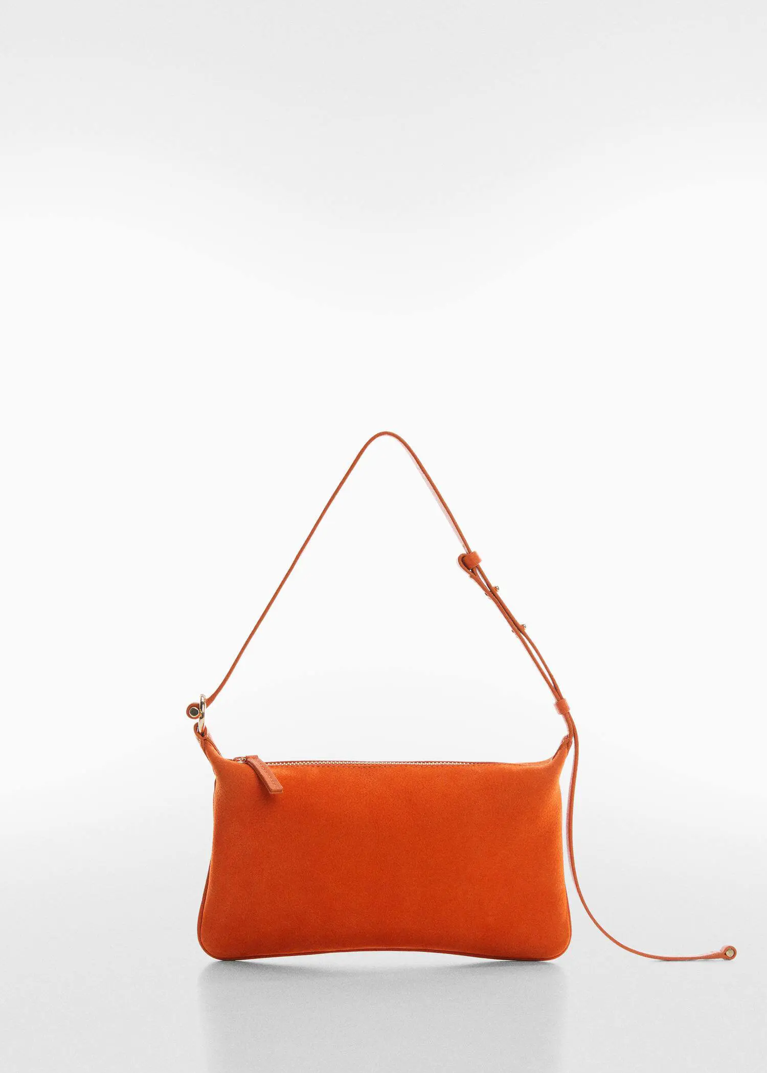 Mango Leather bag with metallic detail. an orange purse is hanging on a white wall. 