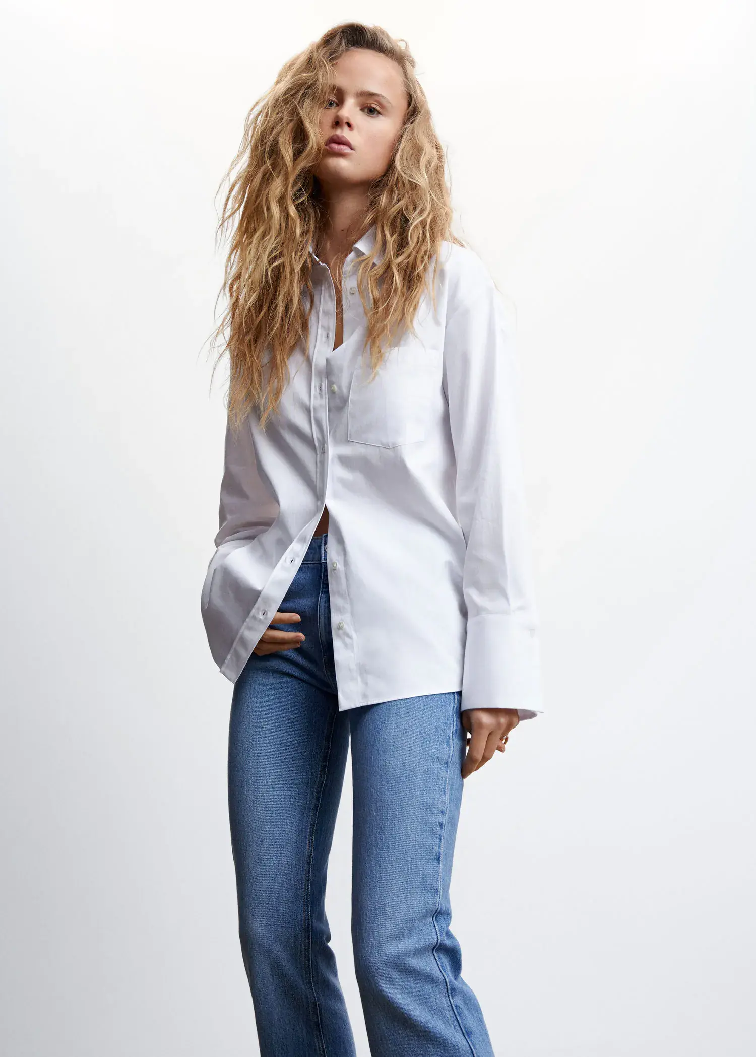 Mango Shirt with adjustable back . a woman wearing a white shirt and jeans. 