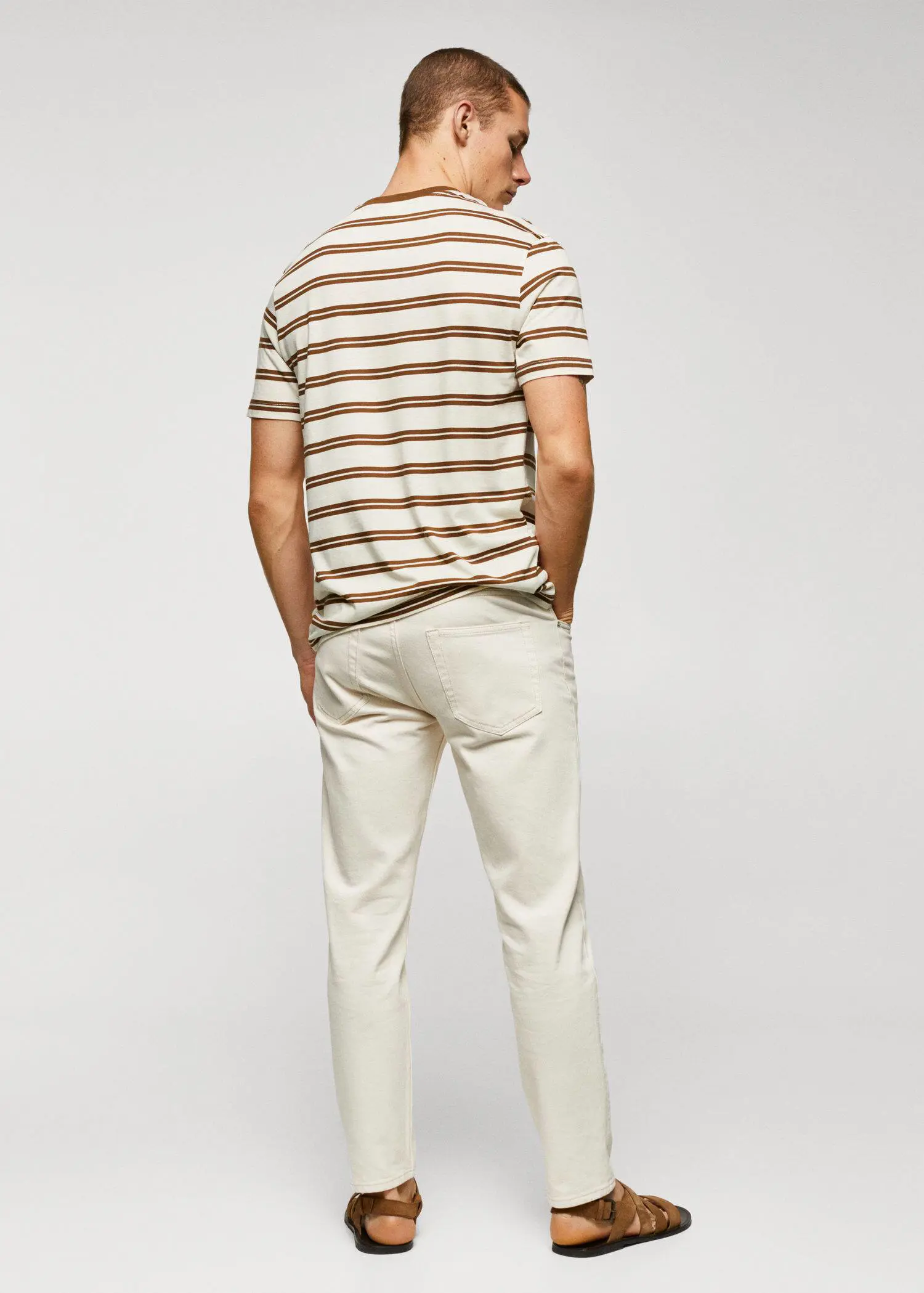 Mango Cotton-modal striped t-shirt. a man standing in front of a white wall. 