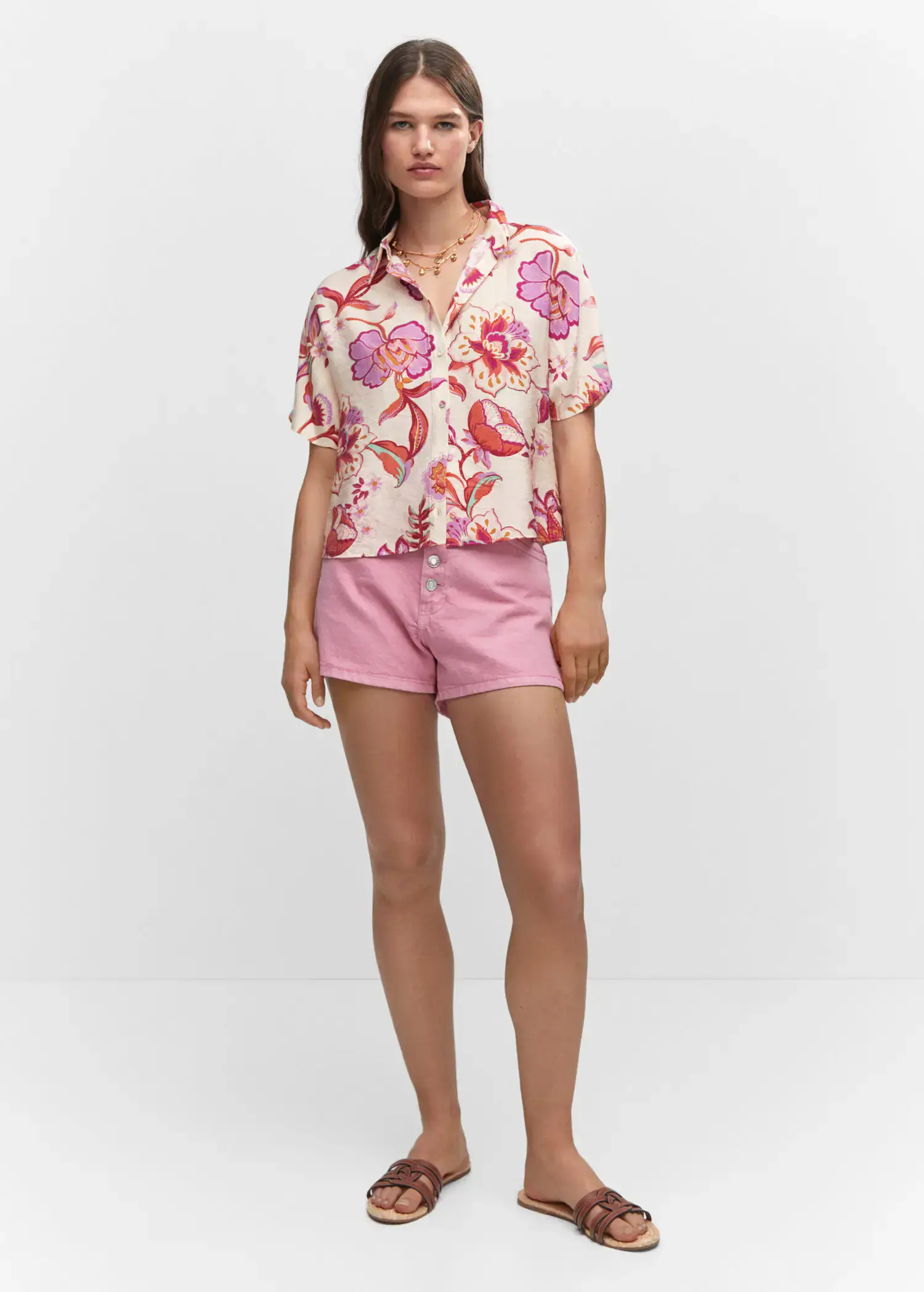 Mango Buttoned printed shirt. a woman wearing pink shorts and a floral shirt. 