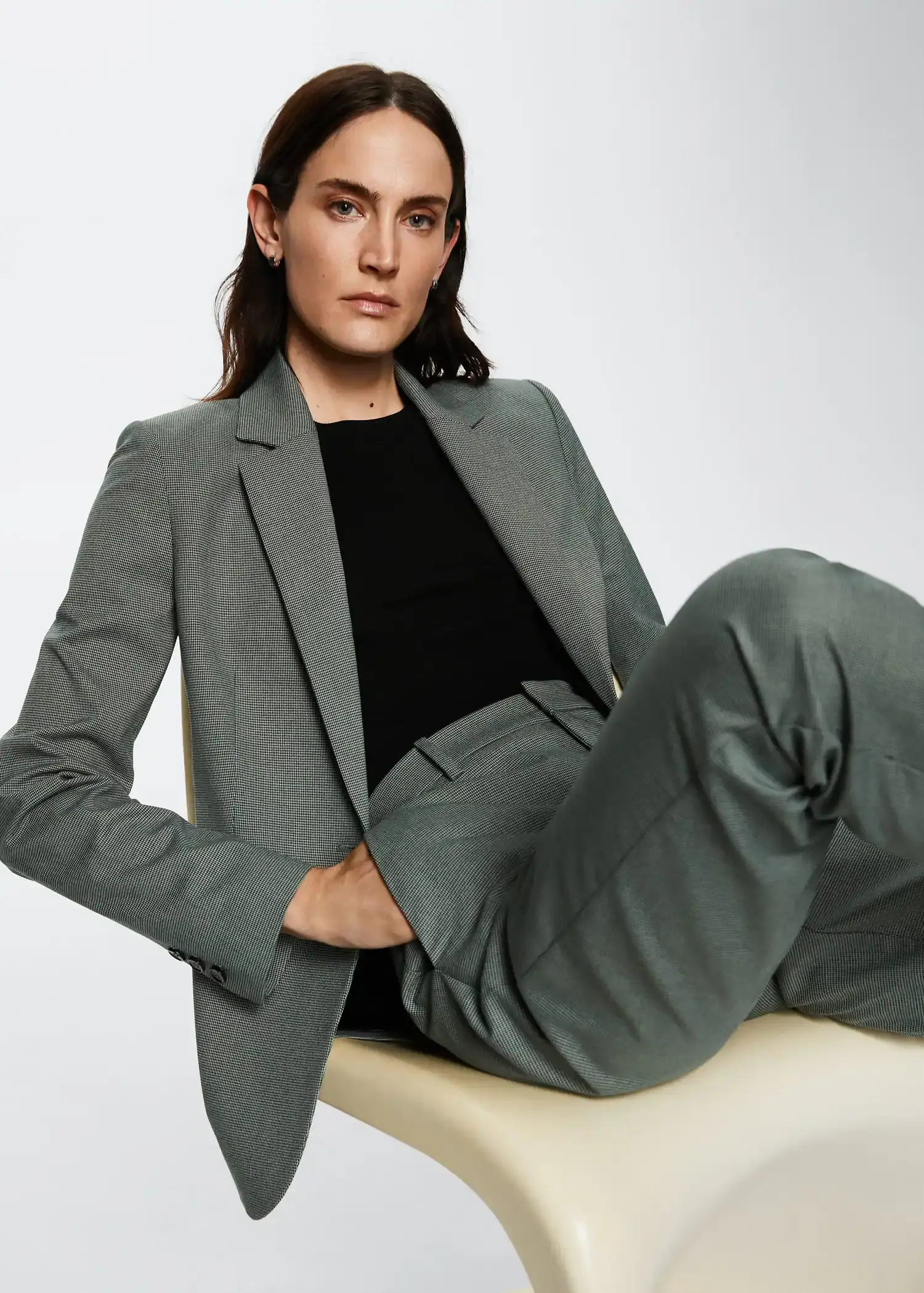 Mango Straight suit pants. a woman sitting on top of a chair wearing a suit. 