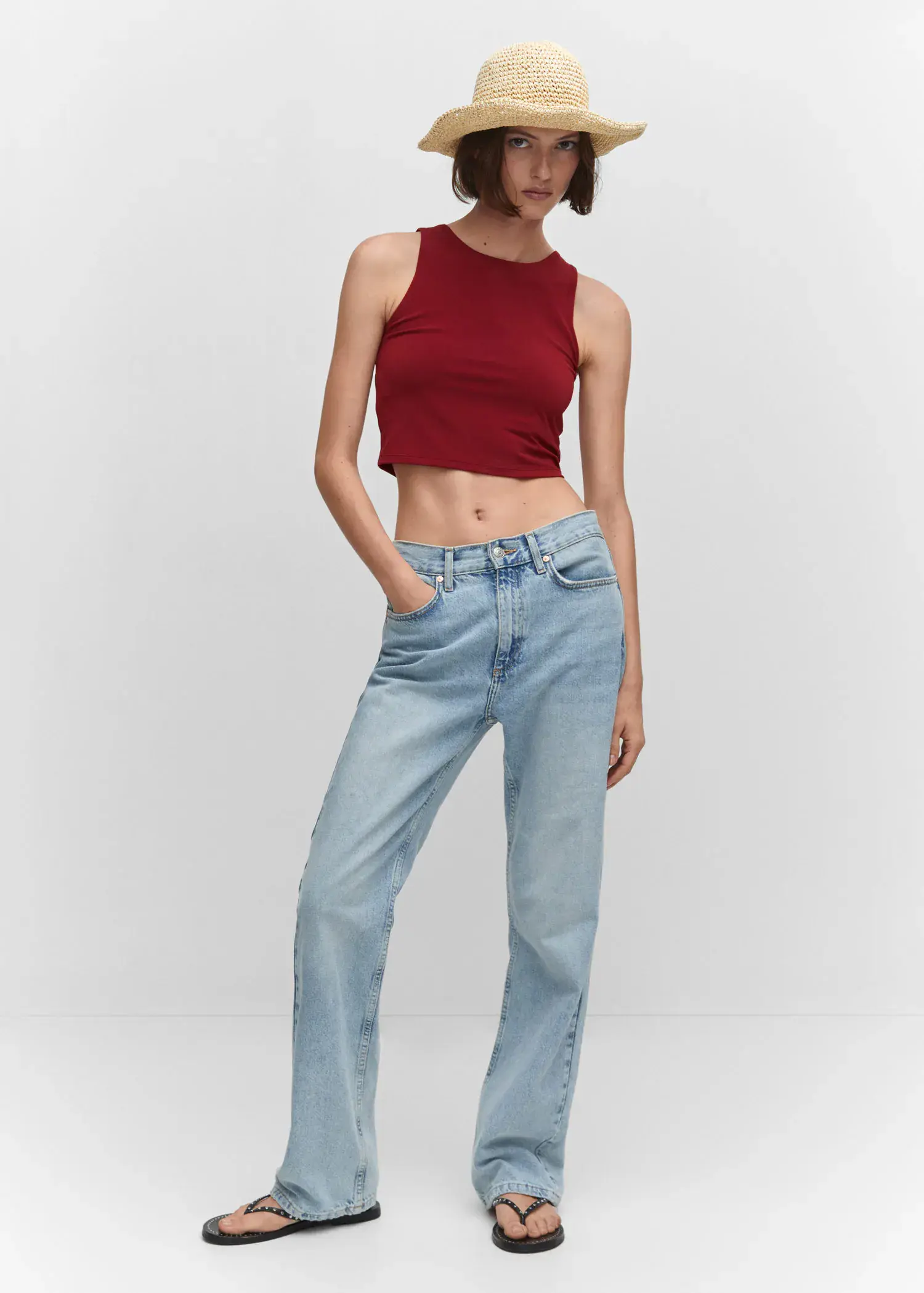 Mango Crop top with halter neck. a woman in a red crop top and blue jeans. 