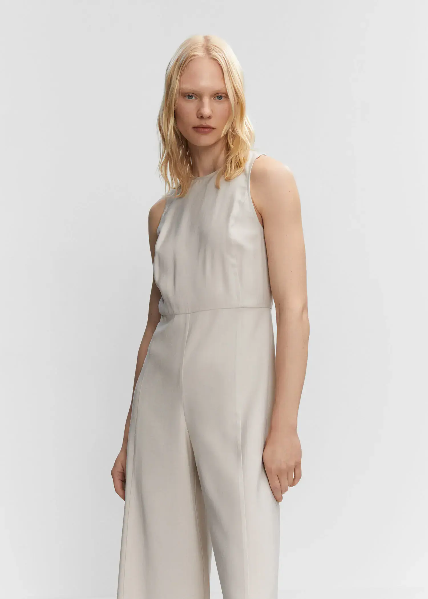 Mango Cropped jumpsuit with straps. a woman in a white dress standing in front of a white wall. 
