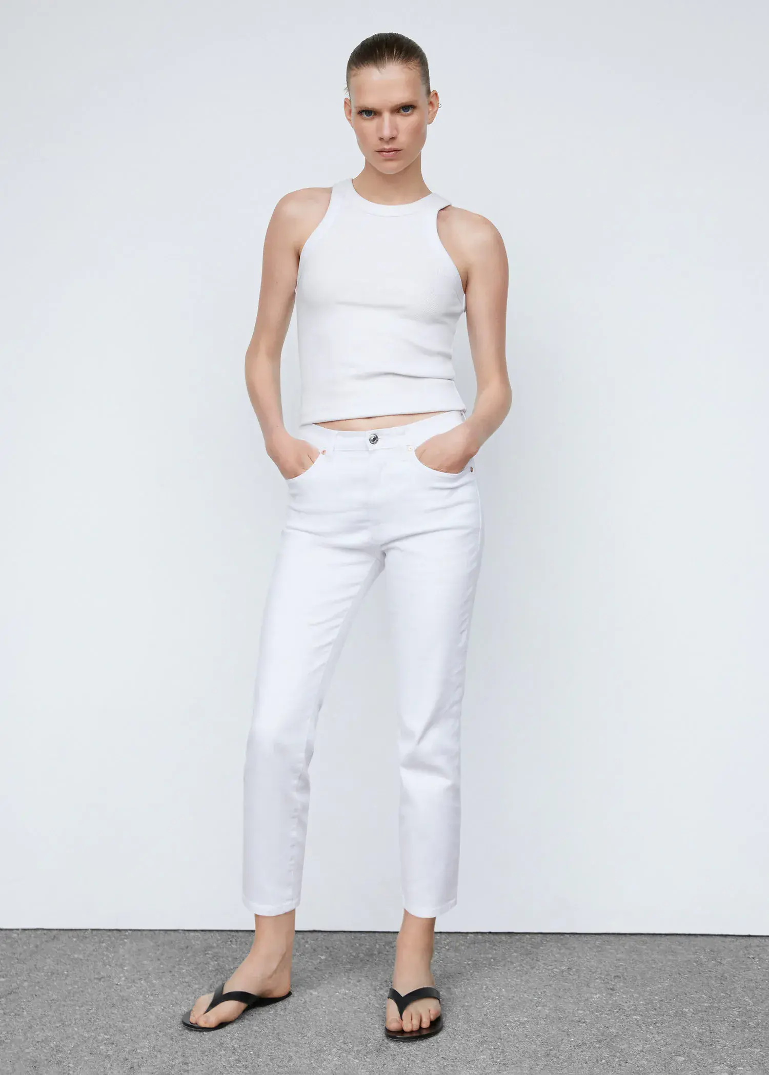 Mango Slim cropped jeans. a woman wearing white pants and a white top. 
