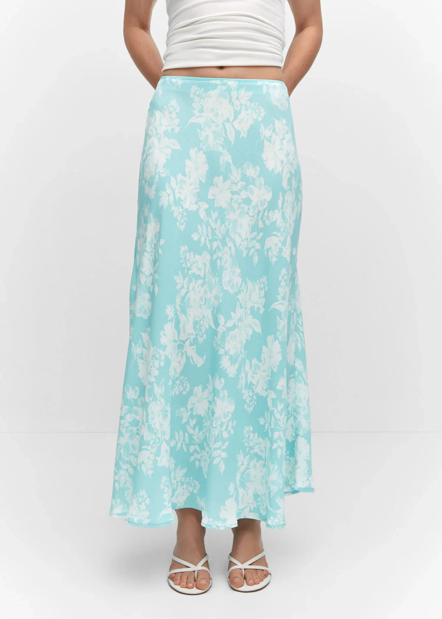 Mango Floral long skirt. a woman wearing a blue floral skirt. 