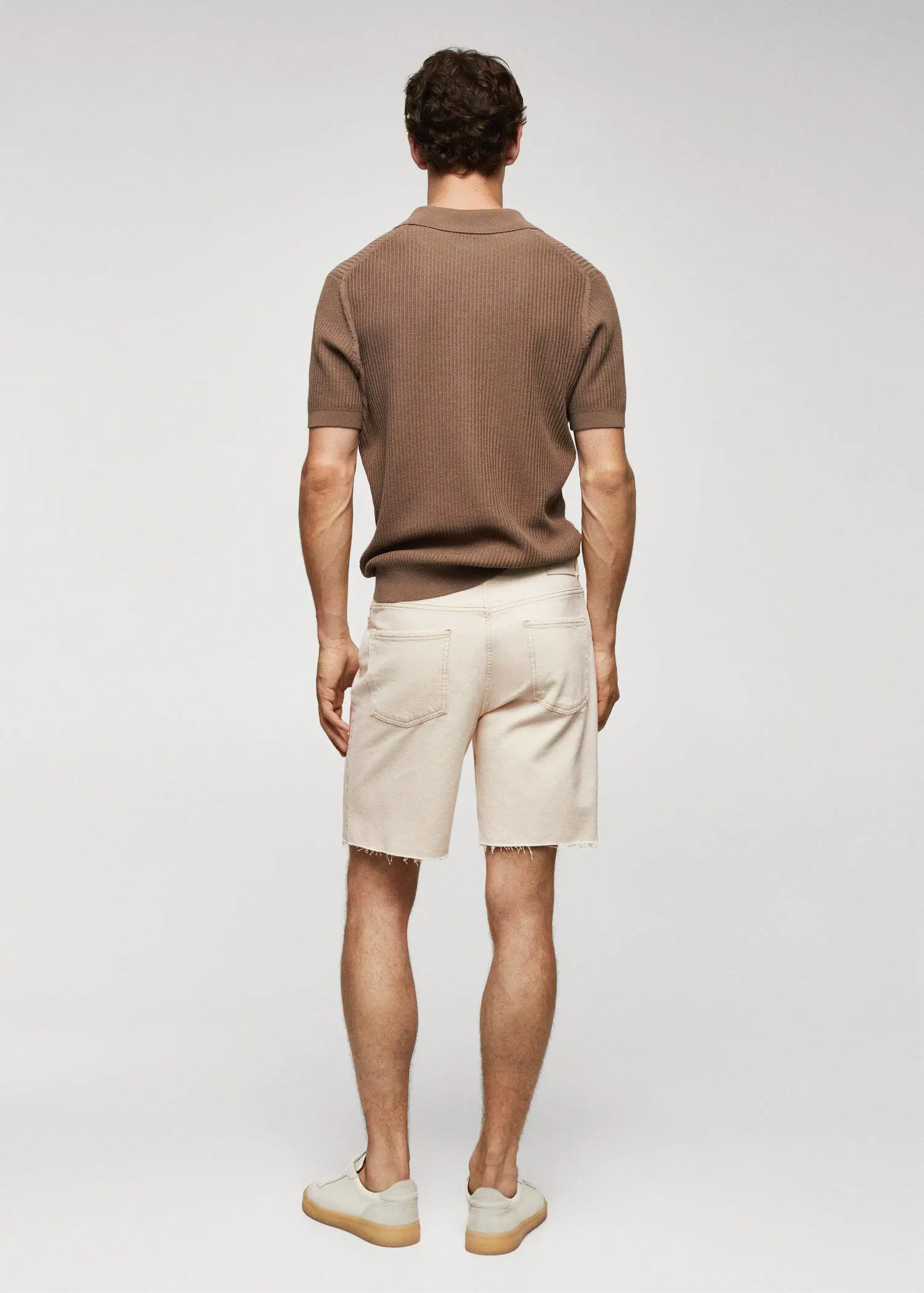 Mango Regular-fit denim bermuda shorts. a man wearing a brown shirt and white shorts. 